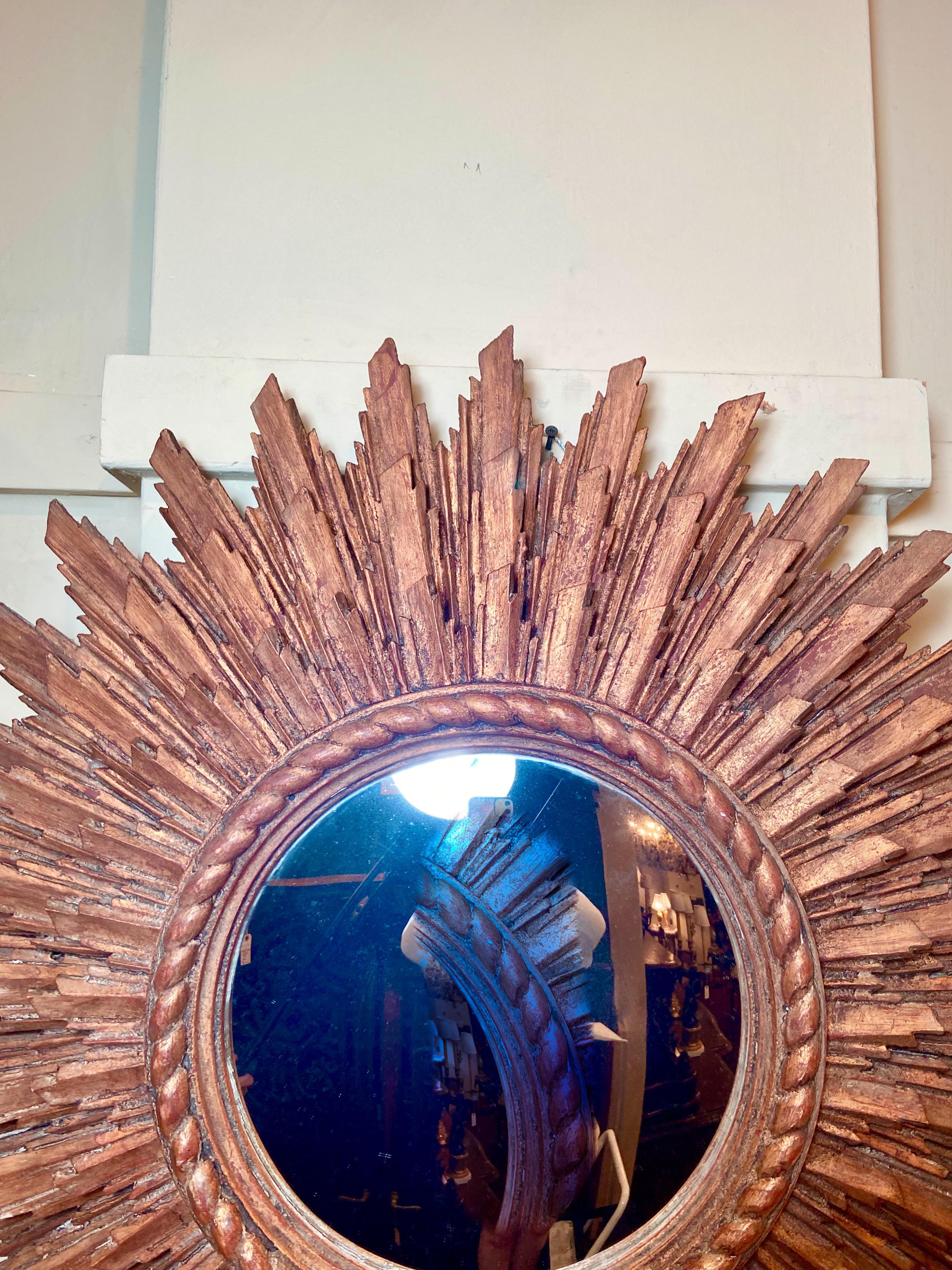 Antique French carved wood with gold leaf starburst mirror, Circa 1920.