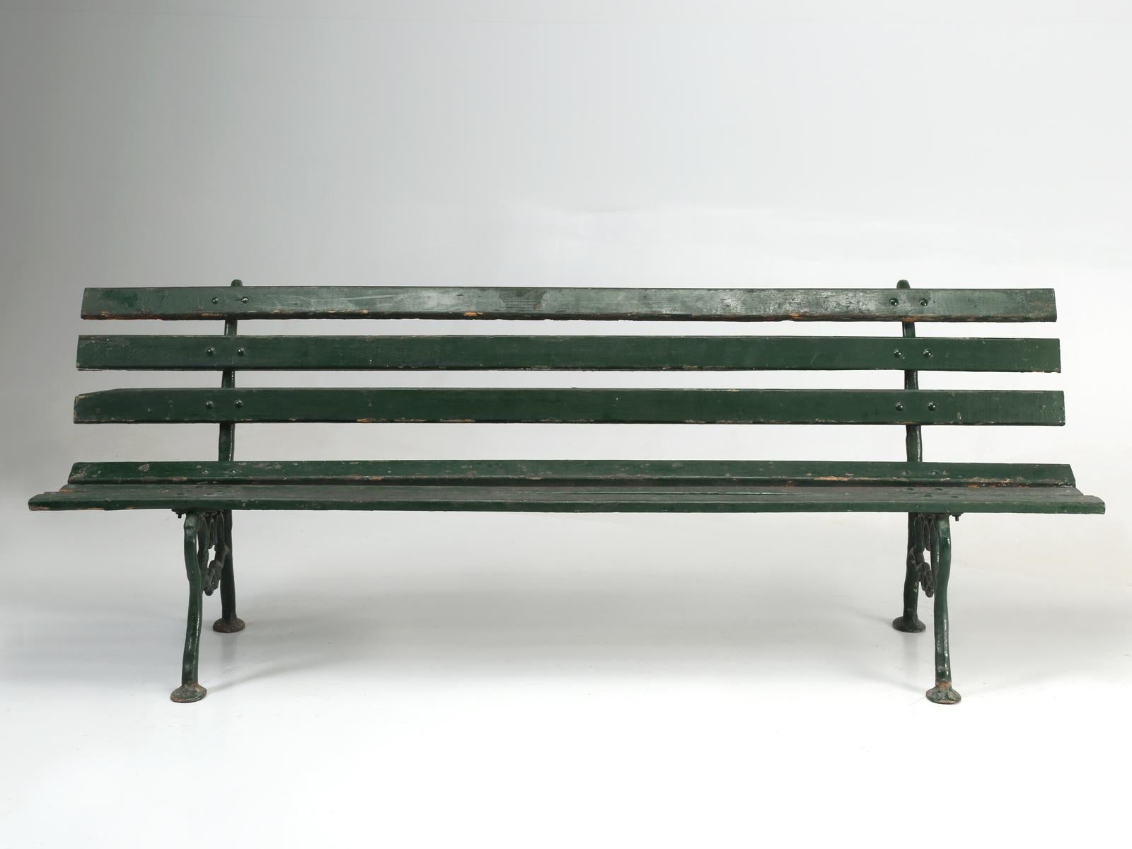 Antique French cast iron and wood garden bench in old paint. Structurally very sound and you can see years of green paint layered up and non-too frequently I might add.
