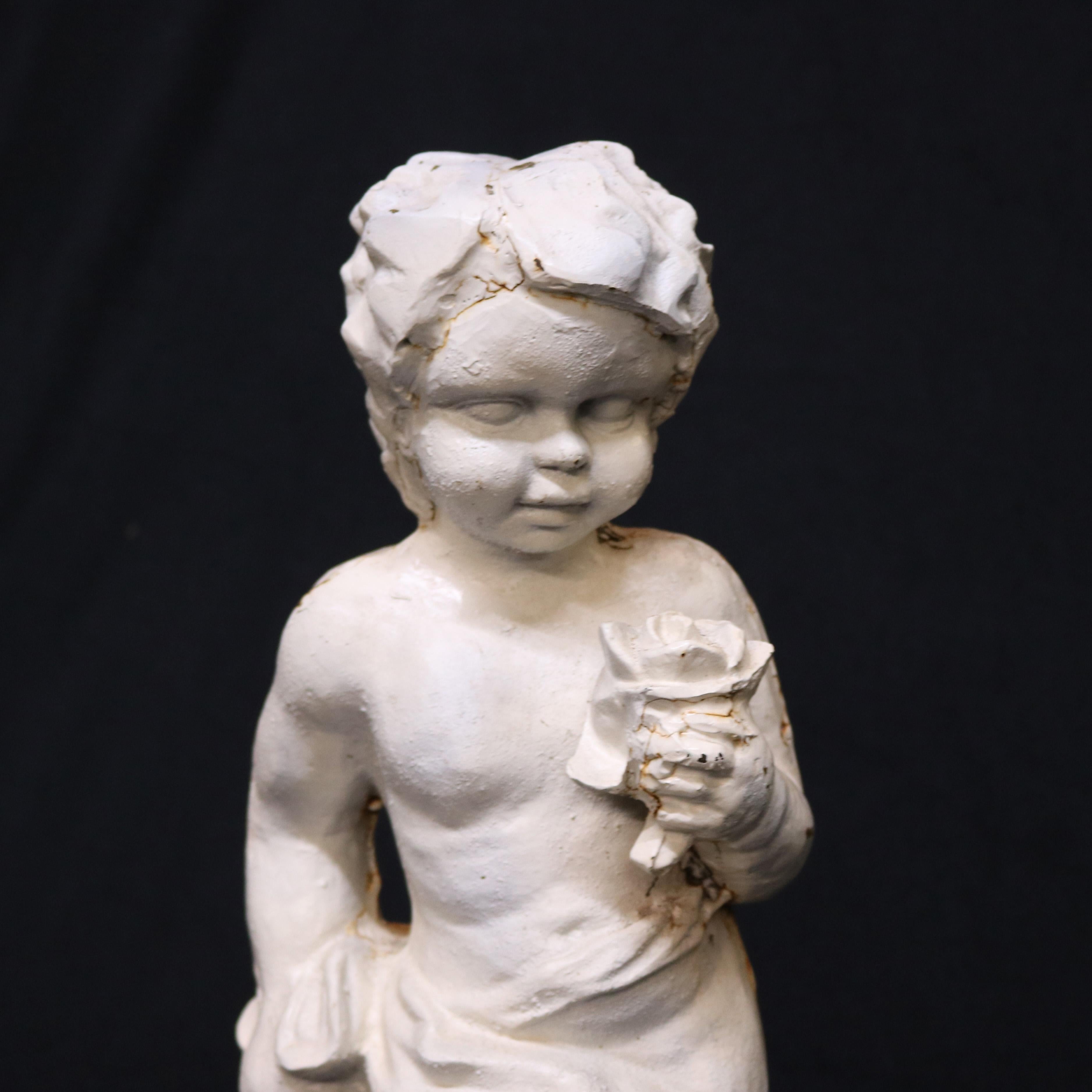 A French figural garden sculpture offers painted cast iron construction and depicts young boy or cherub holding a flower and walking in countryside setting, circa 1940

***DELIVERY NOTICE – Due to COVID-19 we are employing NO-CONTACT PRACTICES in