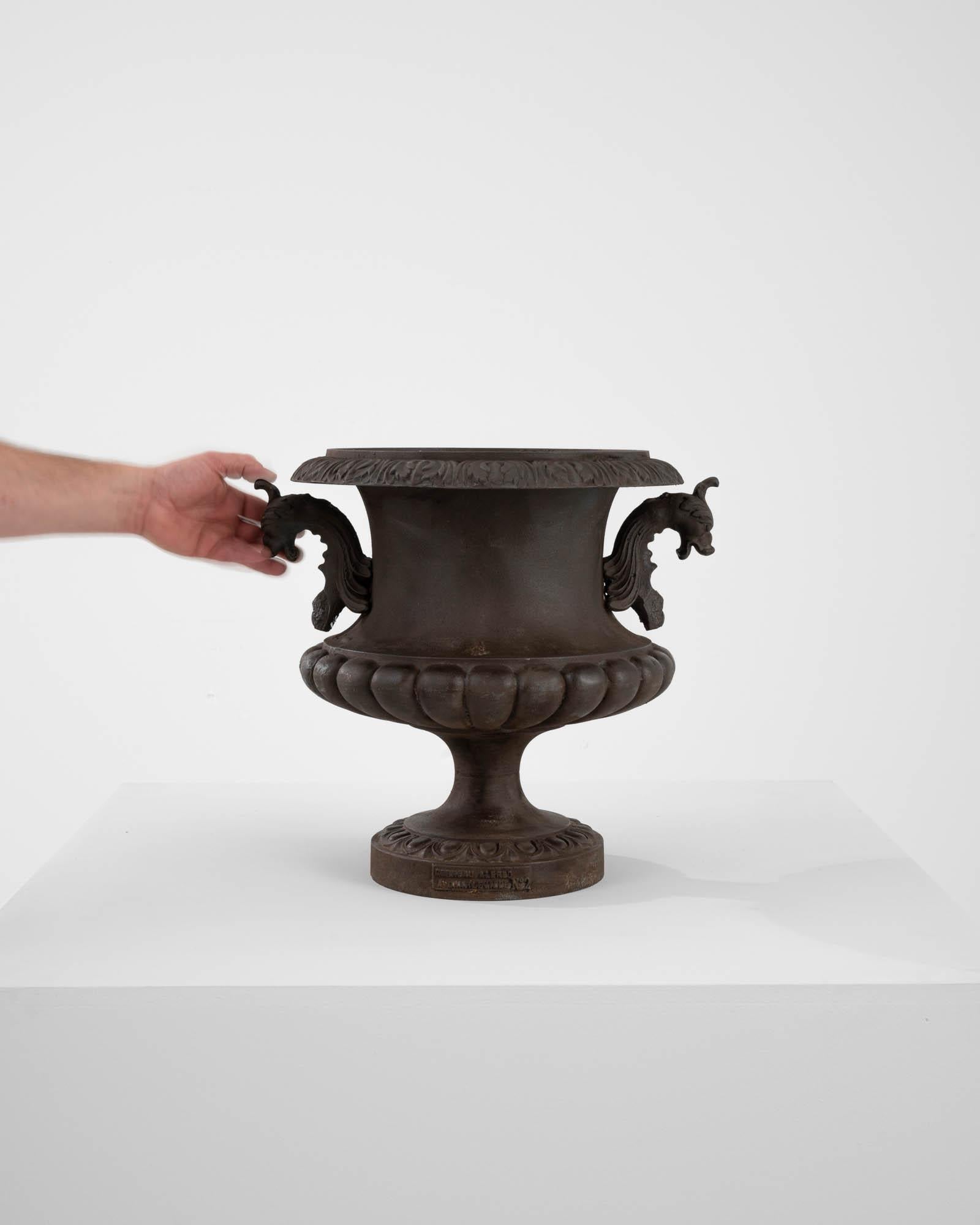 A cast iron planter from France, made in the 1870s. The campana shape resembled an upturned bell with a fluted cupola and broad lip, reminiscent of an opening blossom. It was made by Alfred Corneau, whose cast iron pieces were wildly popular as