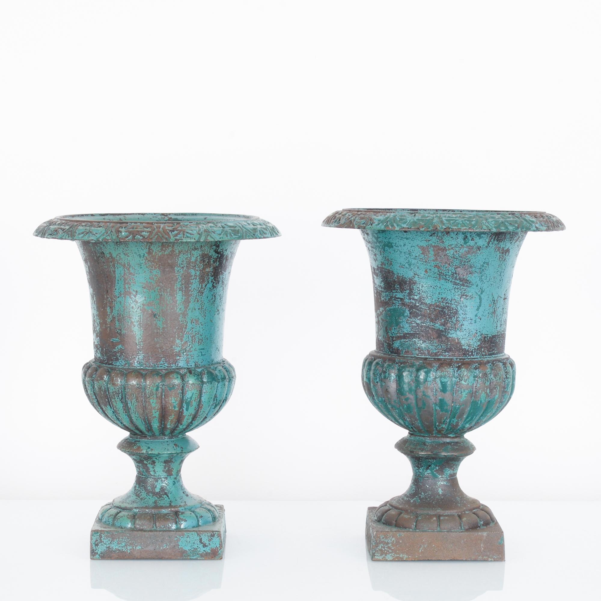 Standing like lilies on pad this striking pair of cast iron planters from France, circa 1900, have a robust lively presence. The finely sculpted bodies of these planters evoke the natural world that will fill them. The bowls display a fine