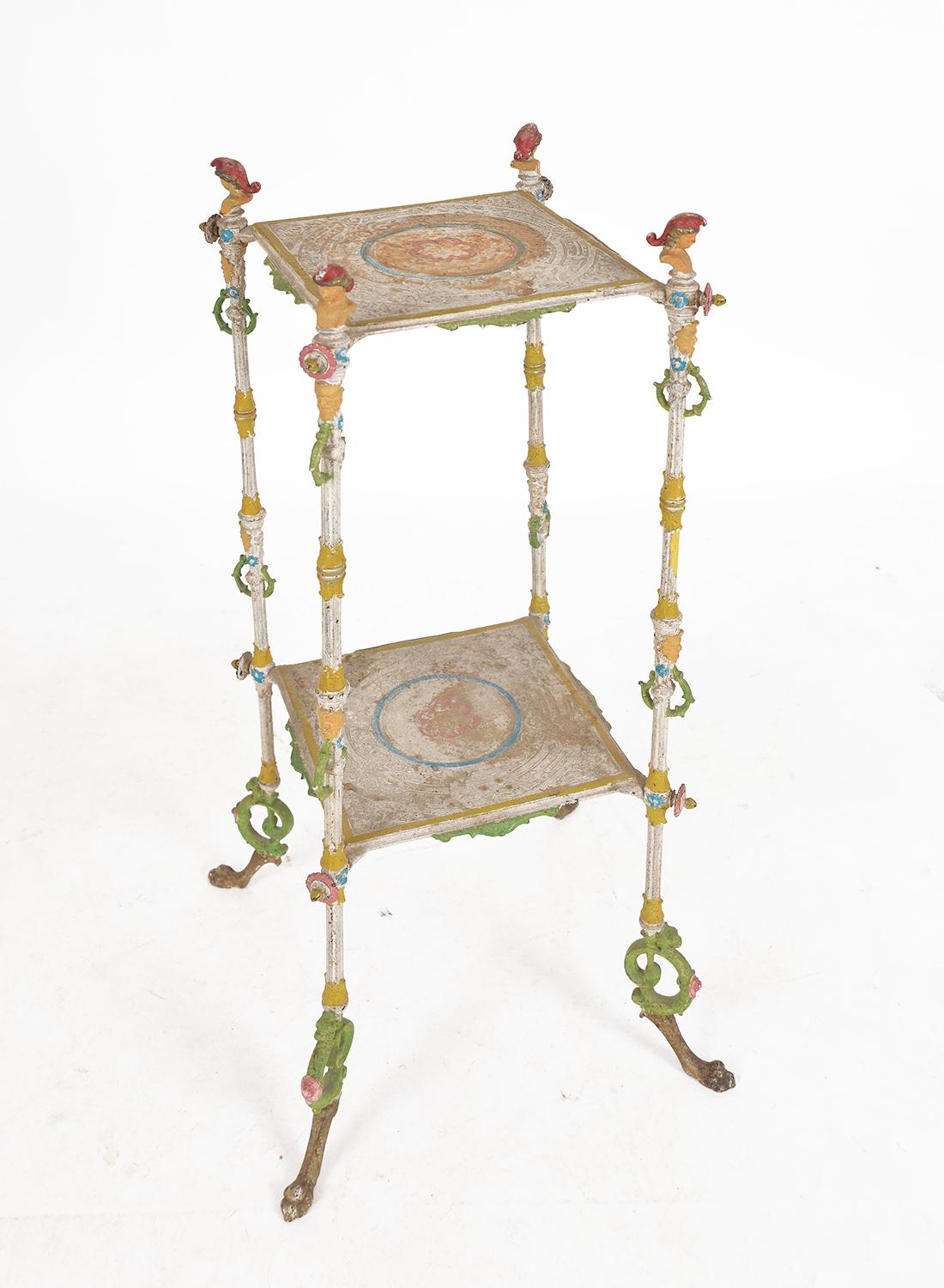 Highly decorative, Belle Époque late 19th century two-tier cast iron polychrome painted torchere on paw feet, painted in a cacophony of colours from milky stone white, green, burgundy and yellow to orange, pink, blue and peach, the paint has the