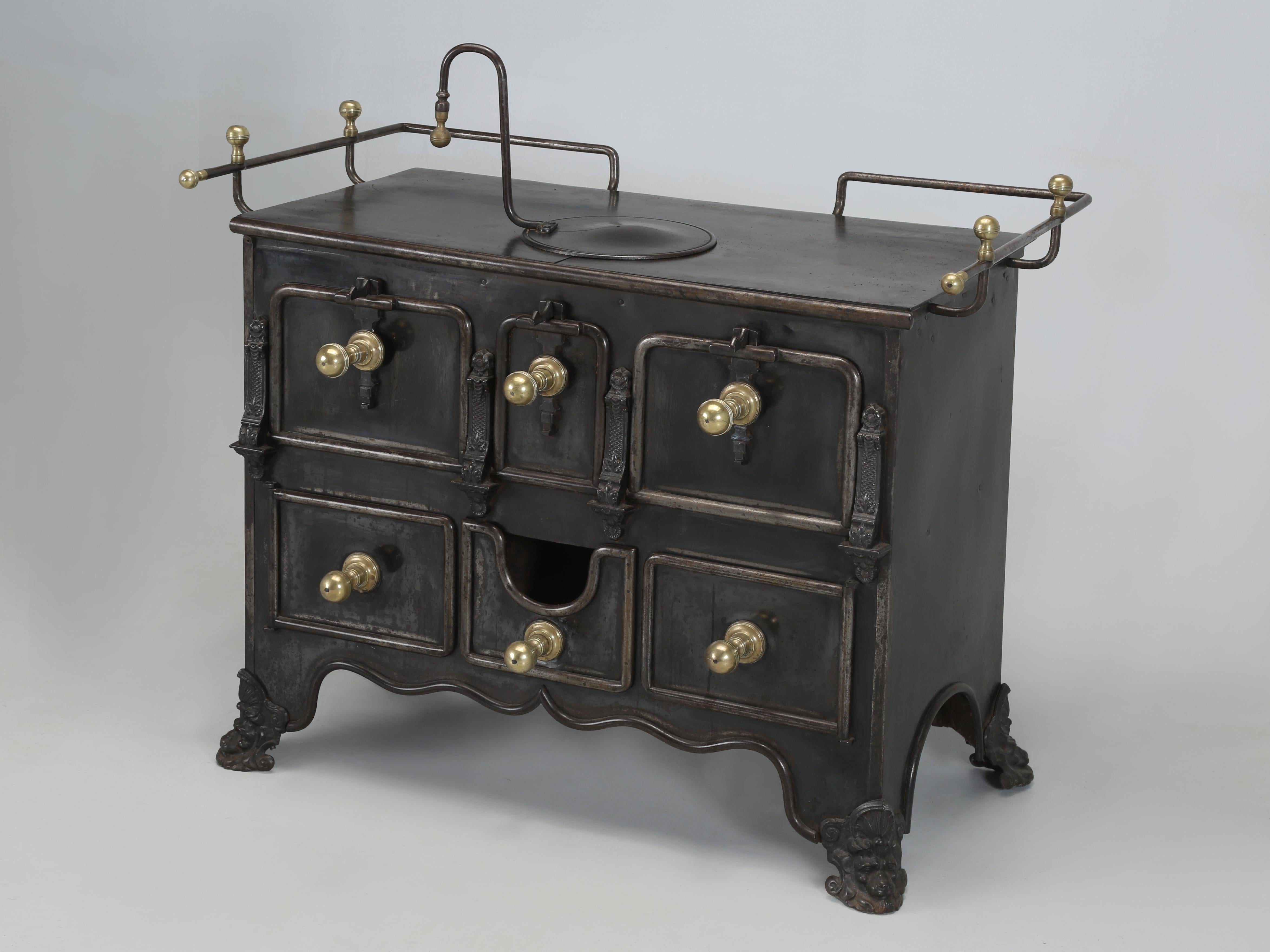 Antique French Wood Stove with a Brass Decorated Gallery and Oversize Brass Handles. In the past we have repurposed Antique French Stoves into incredibly beautiful and unique Bars. This particular Antique French Stove is unquestionably the