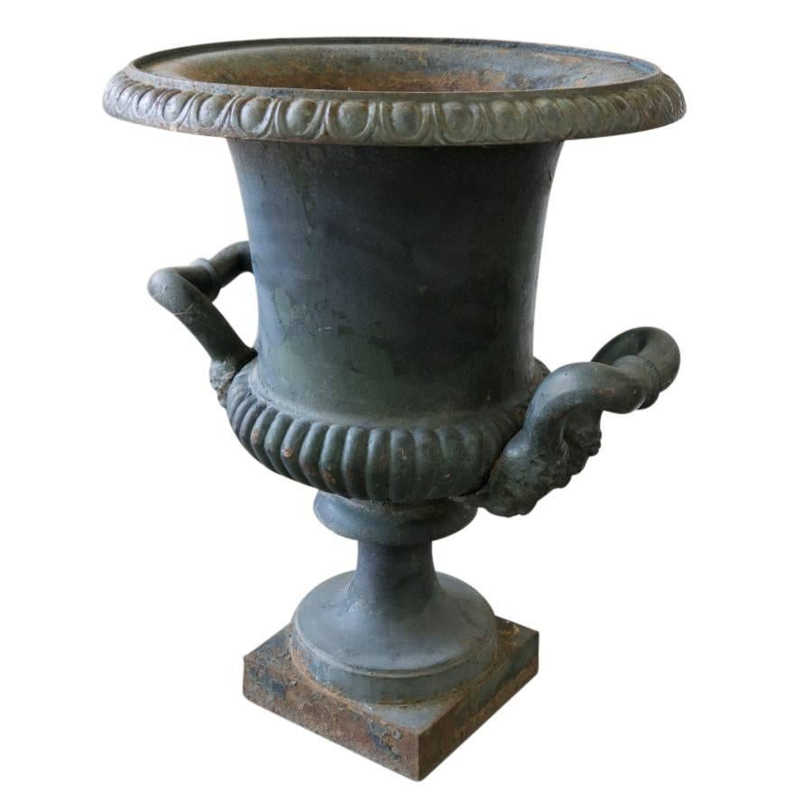 Featuring the original paint and a patina of age and wear this early 20th century French urn is art for the garden that can blend well in the home or a professional setting.