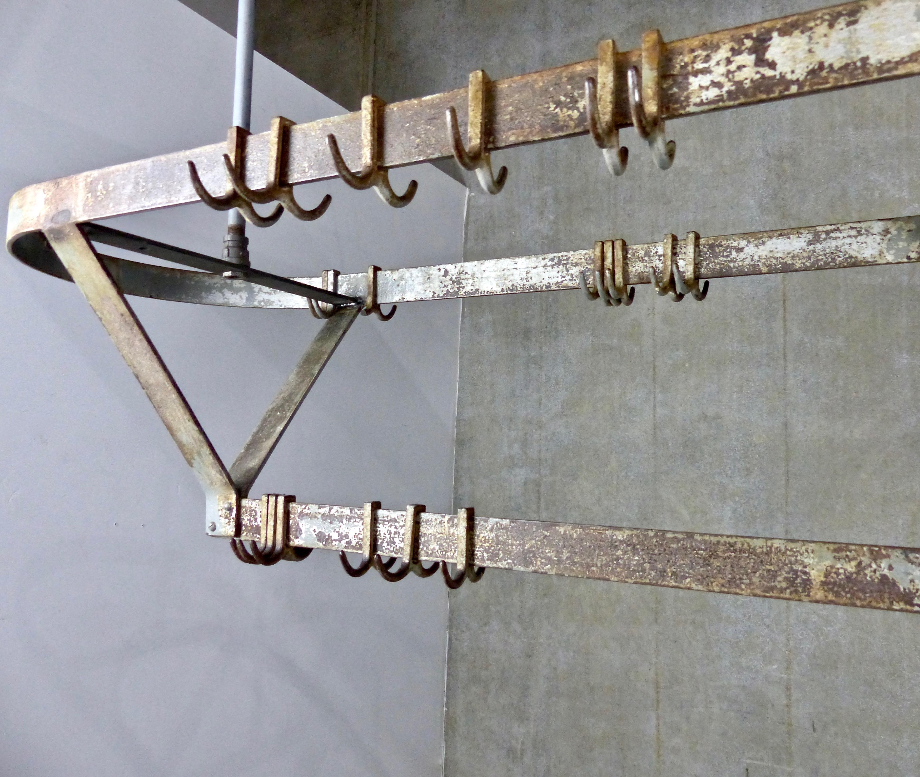 Beautifully patinated, French forged and riveted iron pot rack/holder. Comes complete with its original iron hooks (for hanging pots, etc.) Ceiling mounted; height can be adjusted. An extraordinary showpiece for your kitchen!
Dimensions: 48 H” x 48
