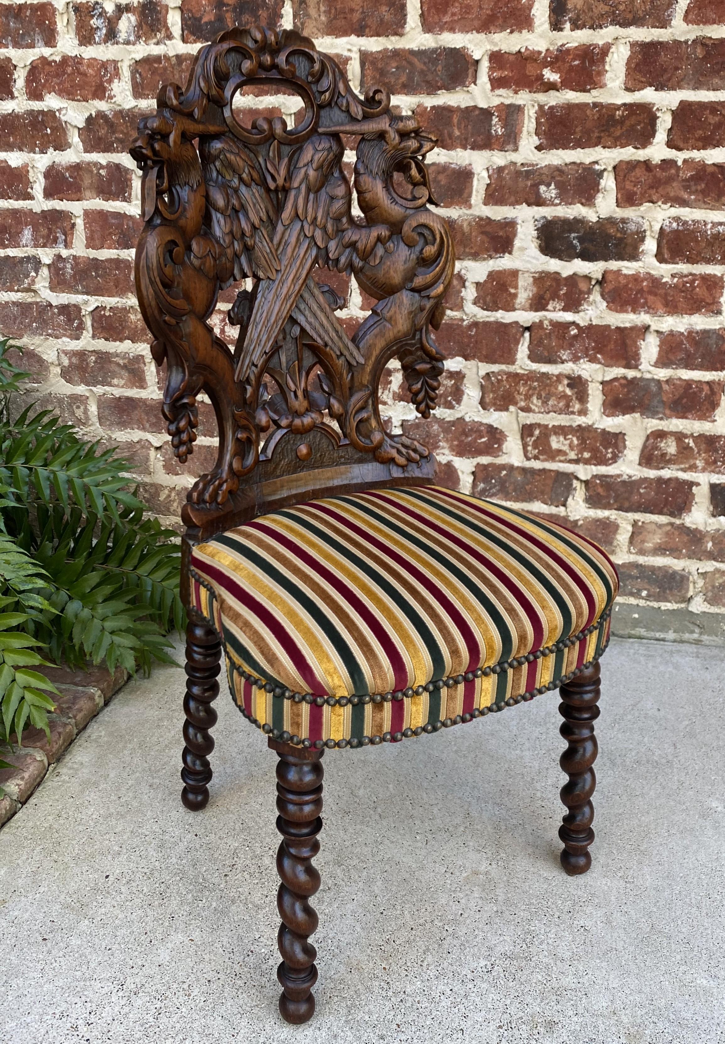 Rare antique French oak Black Forest upholstered chair with barley twist legs~~19th century

Exquisite back is carved from one solid piece of oak~~red, gold and green striped upholstery is in excellent condition~~sturdy barley twist legs~~such a