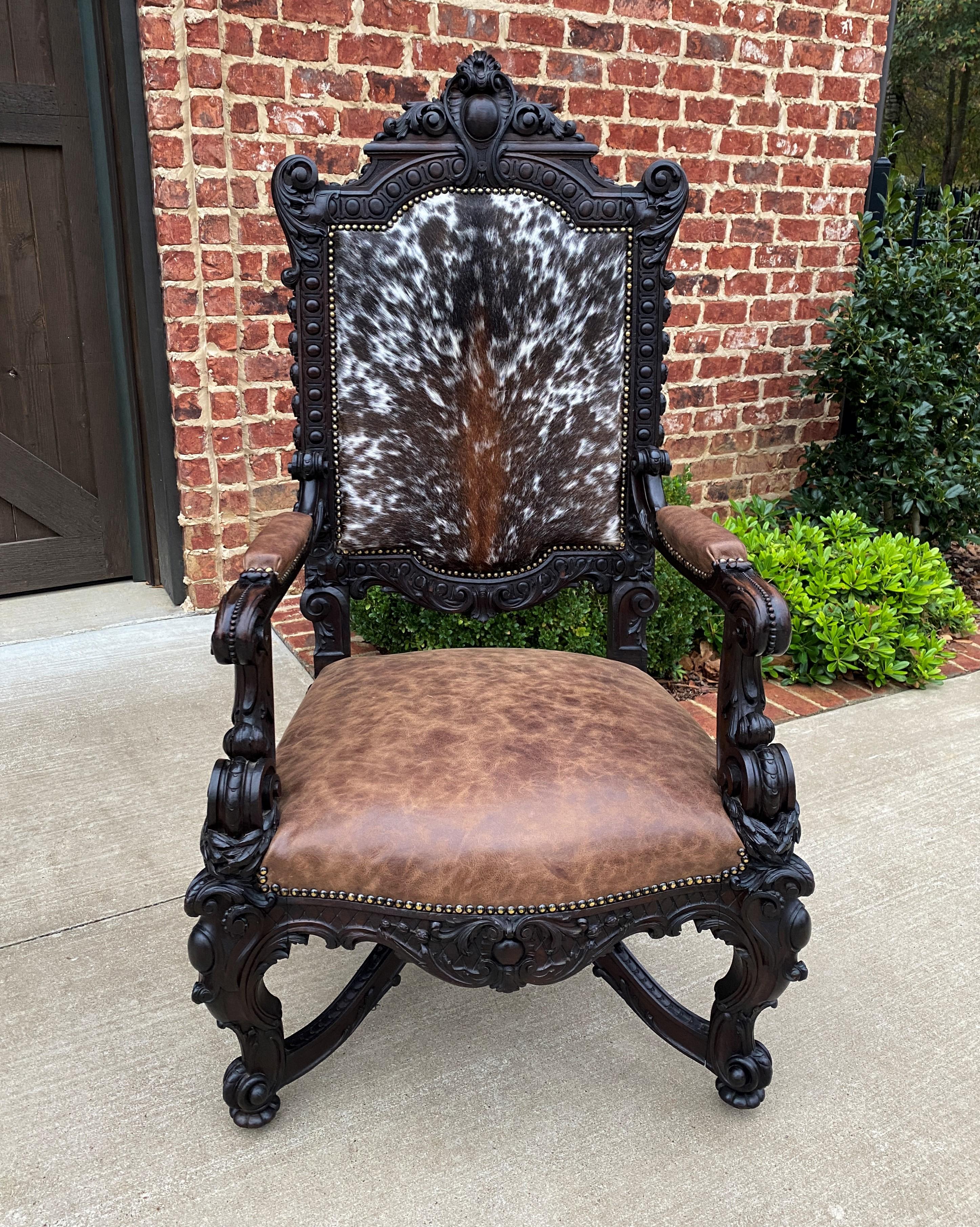 Rare antique French oak Baroque style upholstered arm chair~~Cowhide and leather~~19th century

Notice The Details in the exquisitely hand-carved crown, arms, legs, stretcher and apron~~foliate carved crest and cartouche with bead trim~~newer