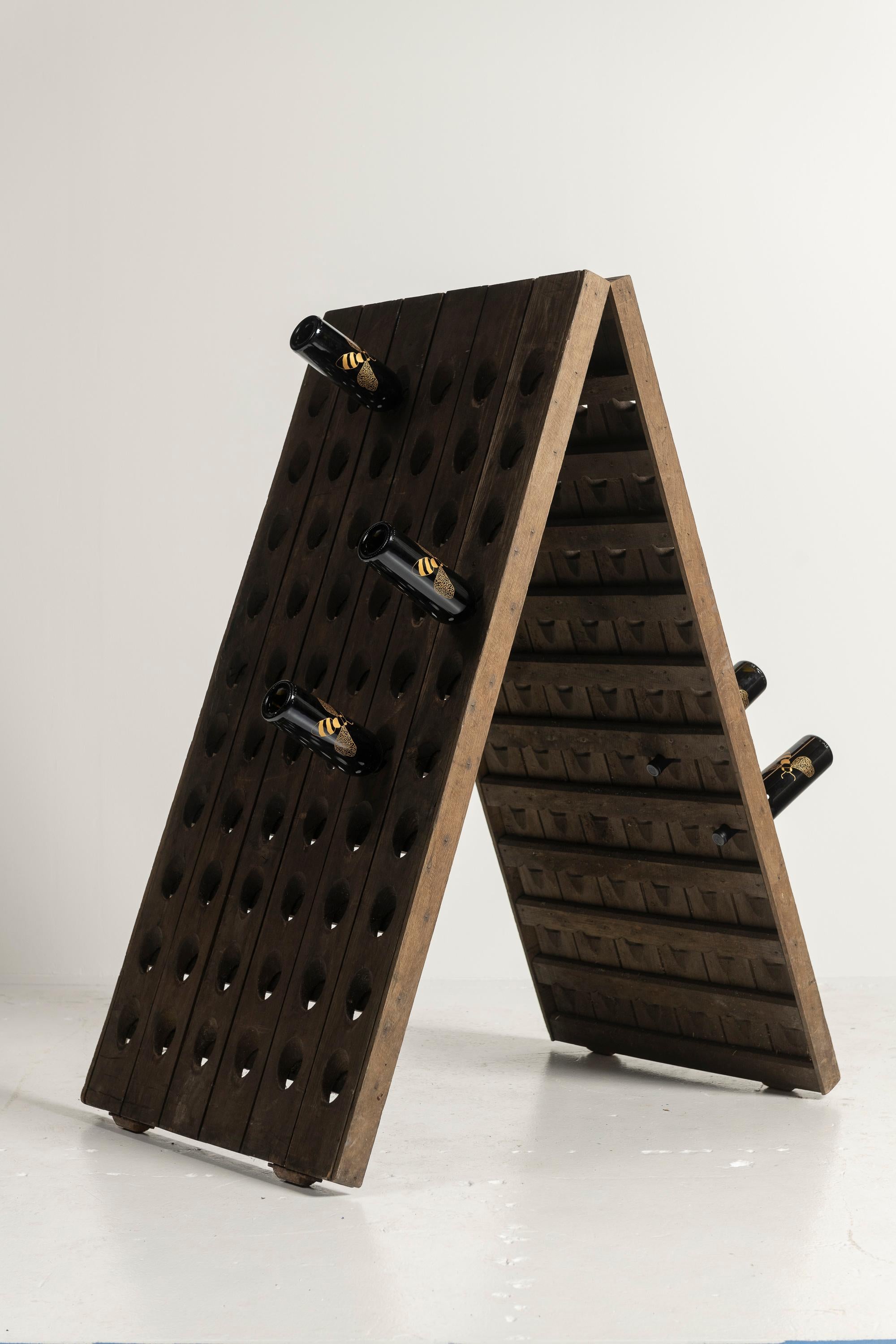 Antique 19th-20th Century oak champagne/wine riddler that has been  stained and weathered beautifully. Standard size, it holds 120 bottles or 10 cases. Perfect storage rack for your collection.