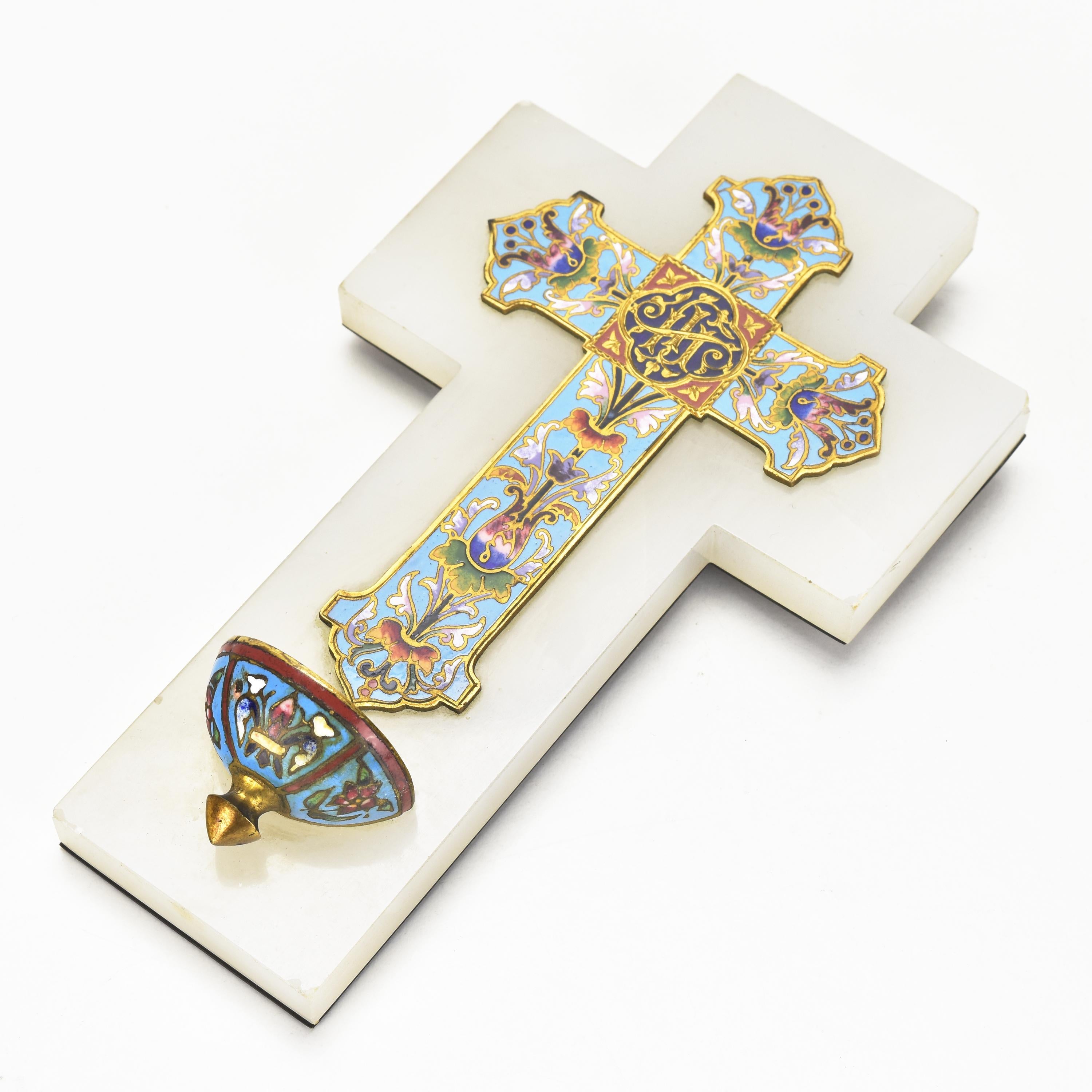 The antique French Victorian gilt champlevé cloisonné crucifix is a magnificent and rare religious artifact that exemplifies the artistry and craftsmanship of the Victorian era. The crucifix is likely made from gilt metal, a process where a thin