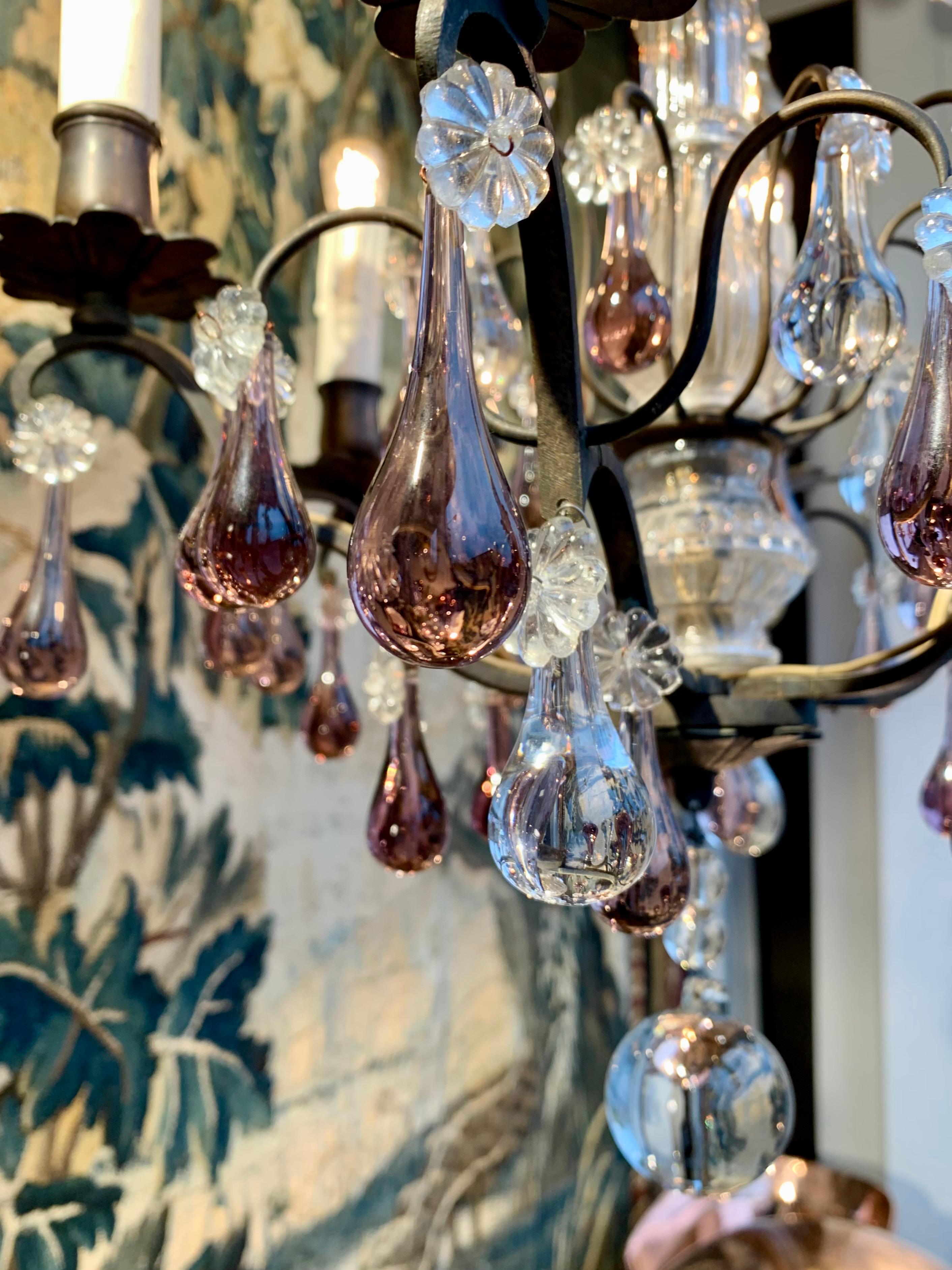 Antique French sweet chandelier with drop prisms in clear and purple glass. The chandelier gives a somewhat 