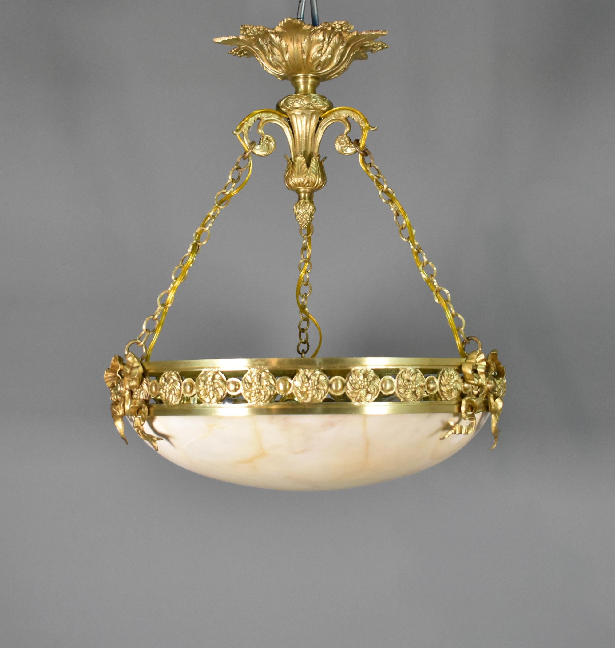 Antique French Chandelier in Bronze and Alabaster Napoleon III Second Empire 

The grand turned alabaster marble bowl sits in a bronze ring decorated with ribbons and floral rosettes, creating a classic and impressive design. 

Hung with bronze
