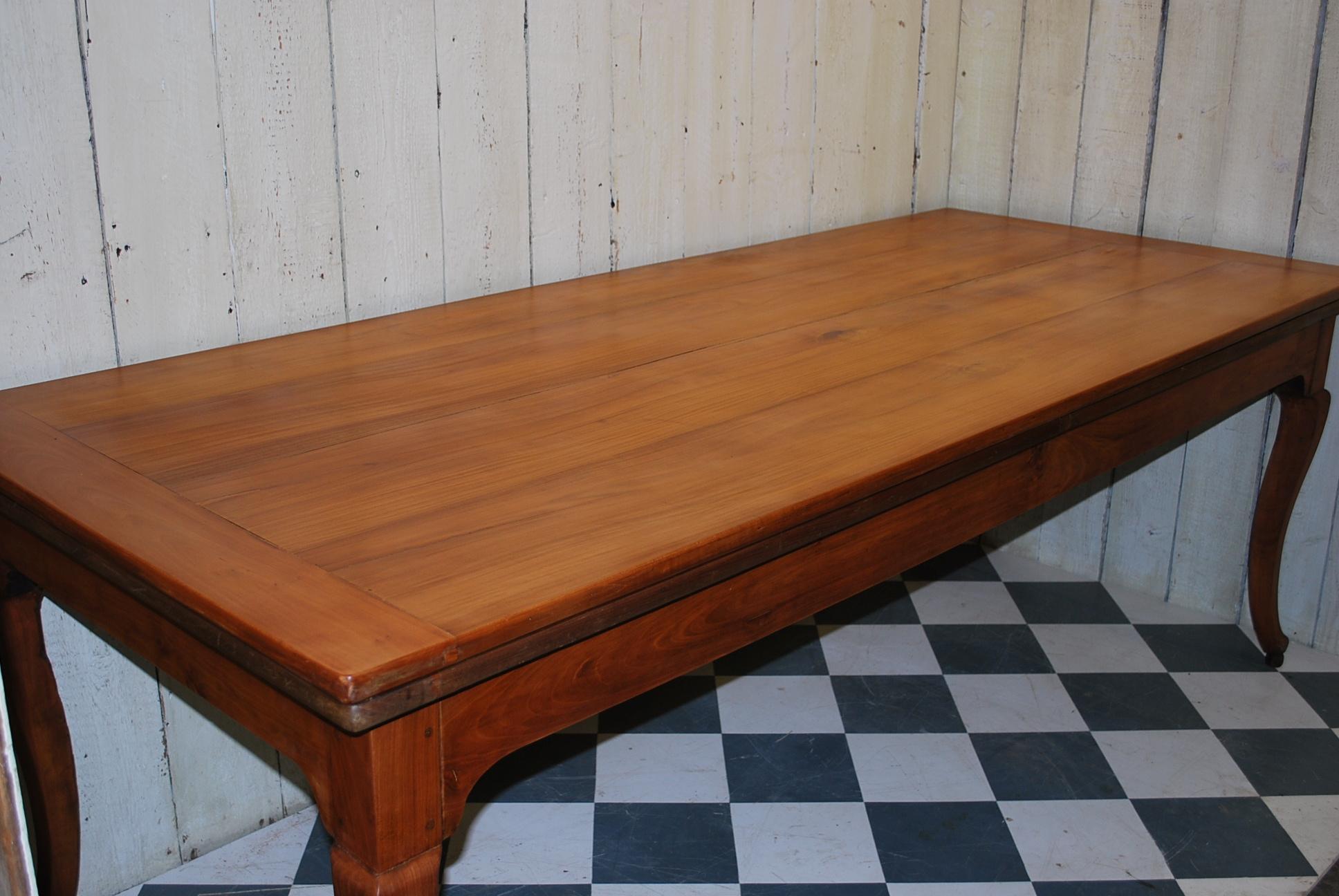 A very good quality French cherry wood farmhouse table, standing on cabriole legs terminating in ball feet. Good color and practical with a good wide top and plenty of legroom all the way around. Will seat eight plus people with two work slides at