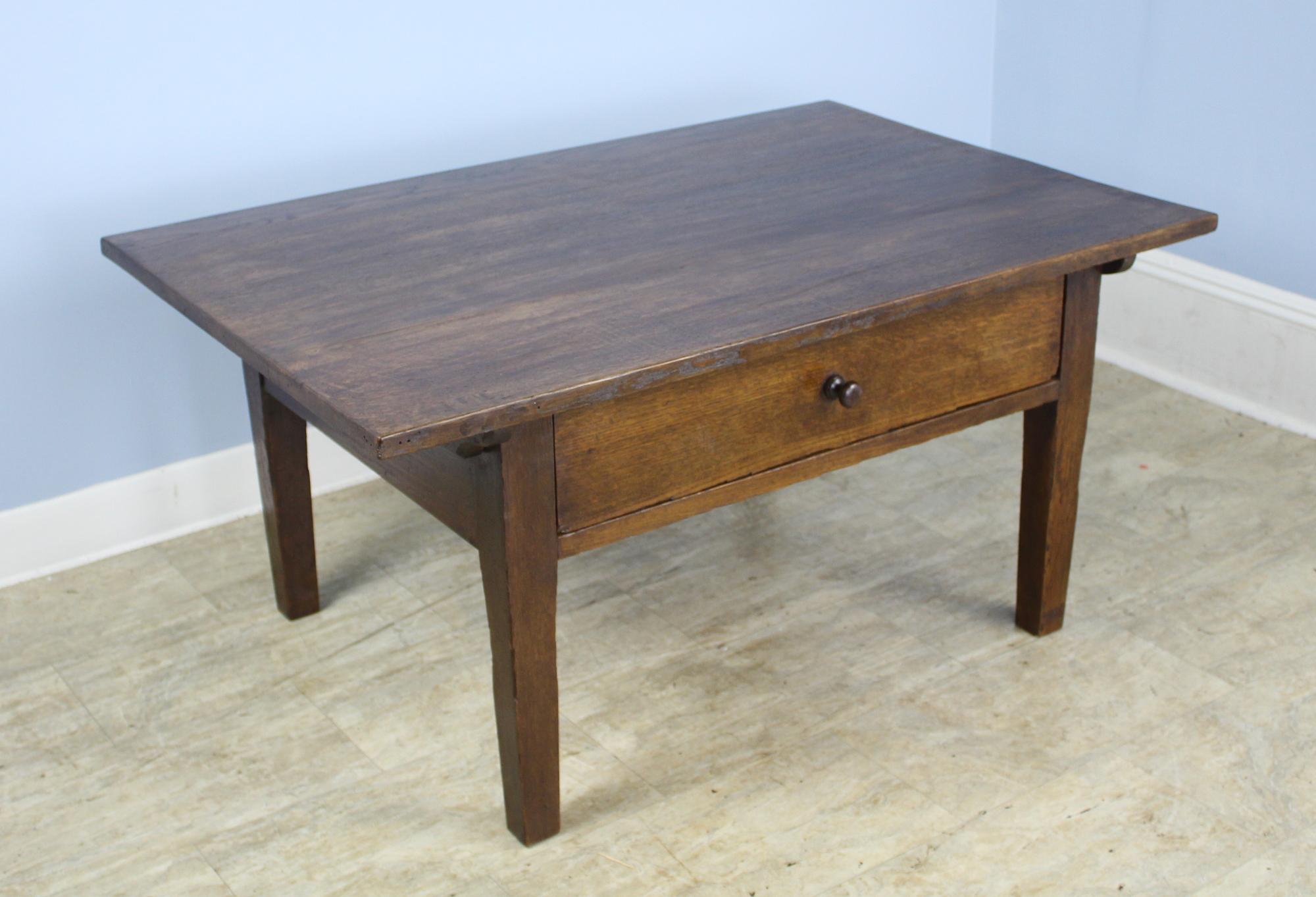 An elegant simple chestnut coffee table with an immaculate and beautifully grained top. Single deep and roomy drawer slides easily and closes snugly.