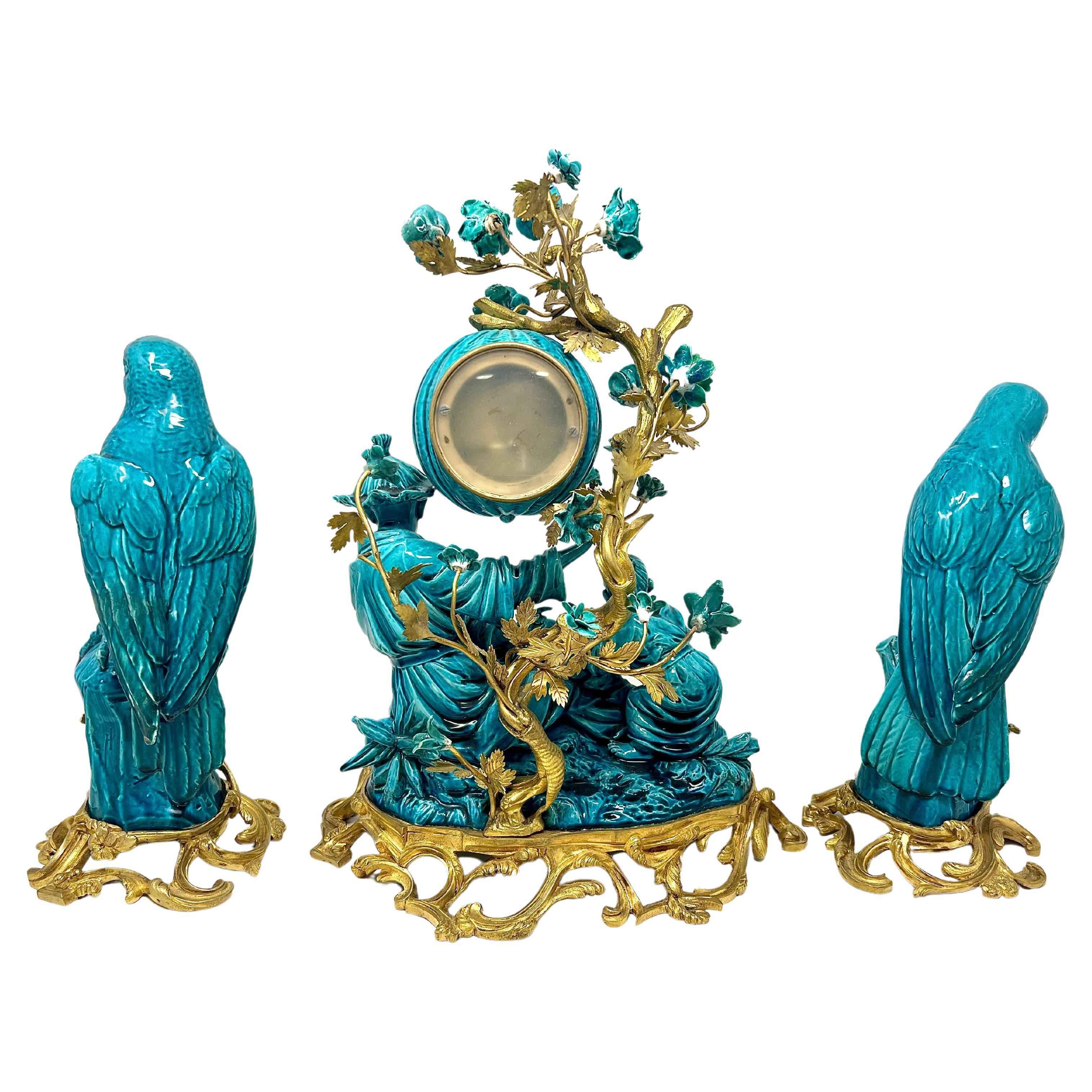 Wonderful Antique French Chinoiserie Style Gold Bronze & Turquoise Glazed Porcelain 3 Piece Garniture Clock Set, Circa 1890's-1900.
Clock: 16 inches in height x 11 inches in width x 9 inches in depth 
Birds: 12 inches in height x 6 inches in width x