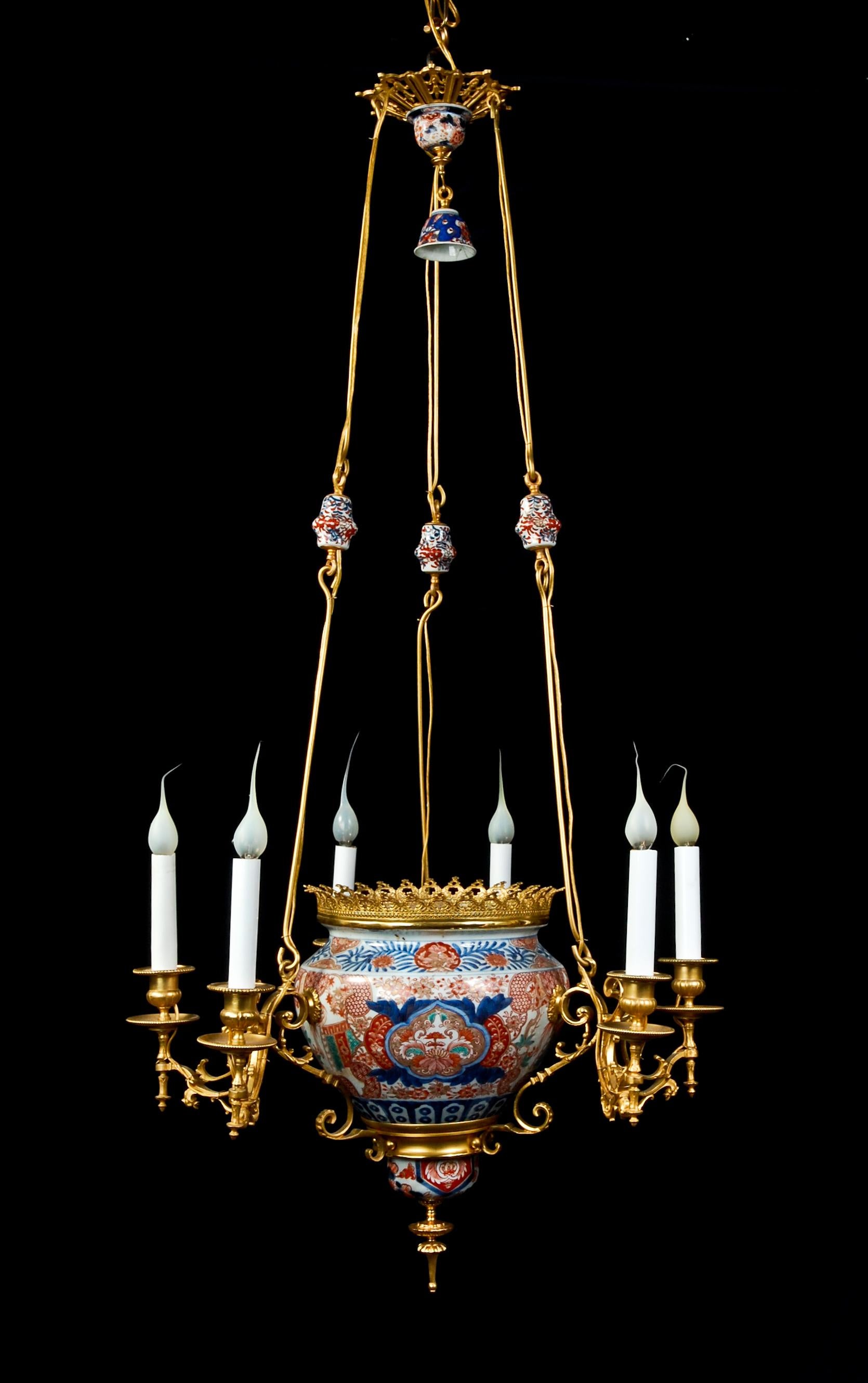 A unique antique French chinoiserie style gilt bronze-mounted Chinese porcelain chandelier embellished with a central hand-painted Chinese porcelain bowl and adorned with fine gilt bronze arms.