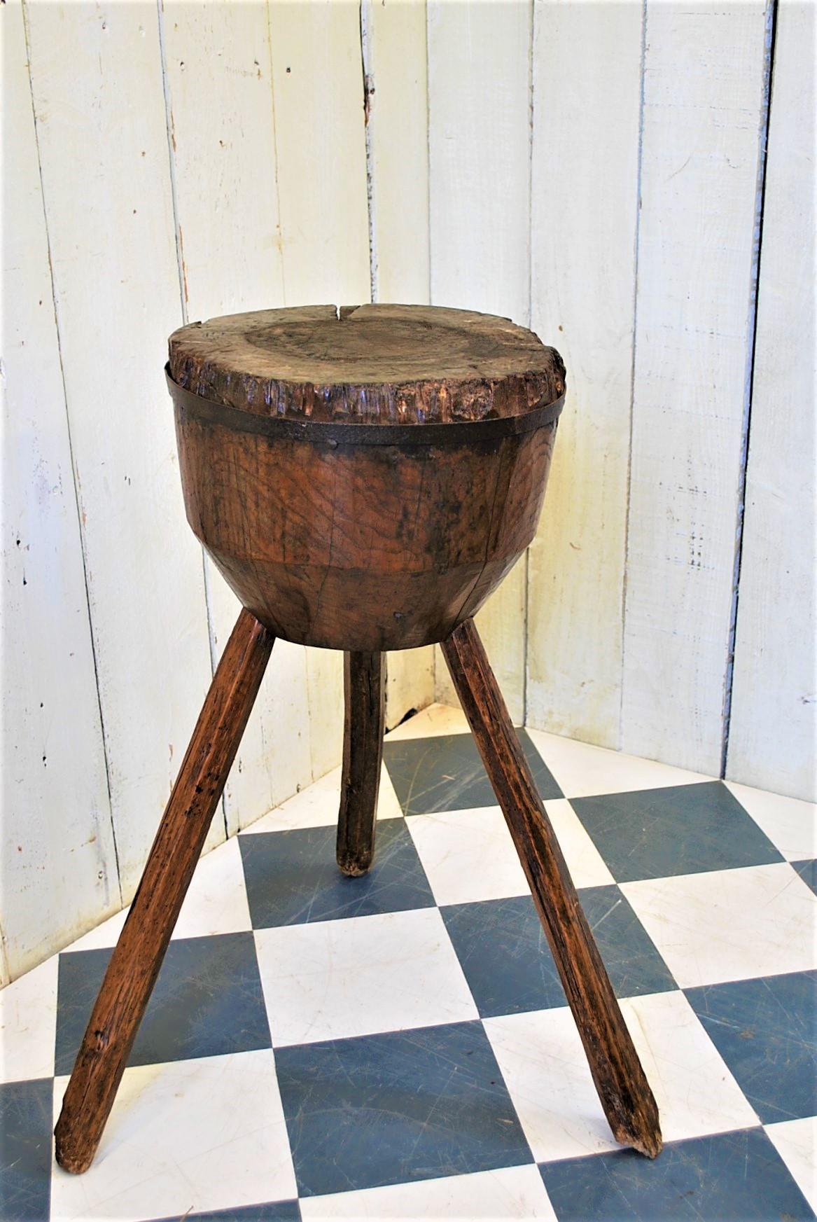 Lovely small French butcher's block/tripod table, made in patinated oak. Standing on three primitive chamfered legs, whilst the block shapes down at the base. Around the top is a good forged iron band. Ideal as a primitive side table. An excellent