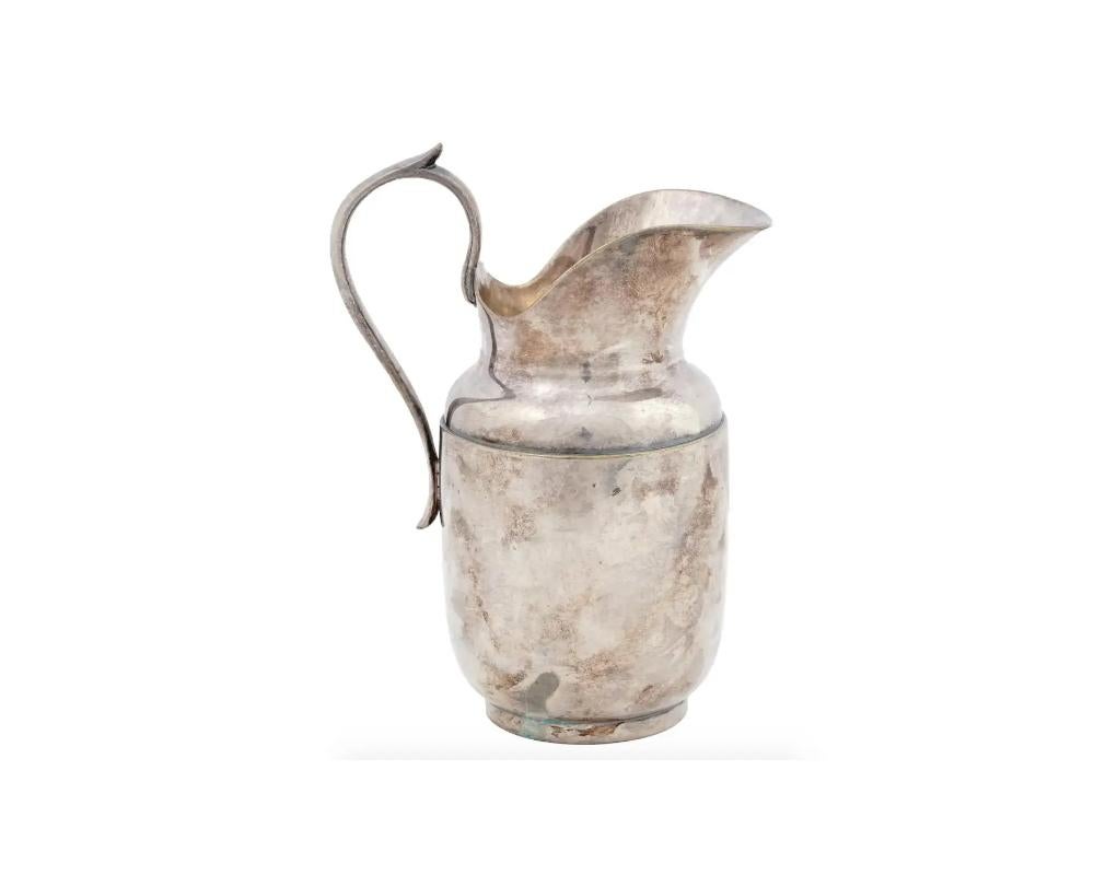 An antique French silver jug manufactured by Christofle with a raised handle. Marked with the manufacturer marks and numbered to the base. Circa the late 19th or early 20th century. Weight: 250 g. Antique Silver Jugs And Pitchers And Drinkware