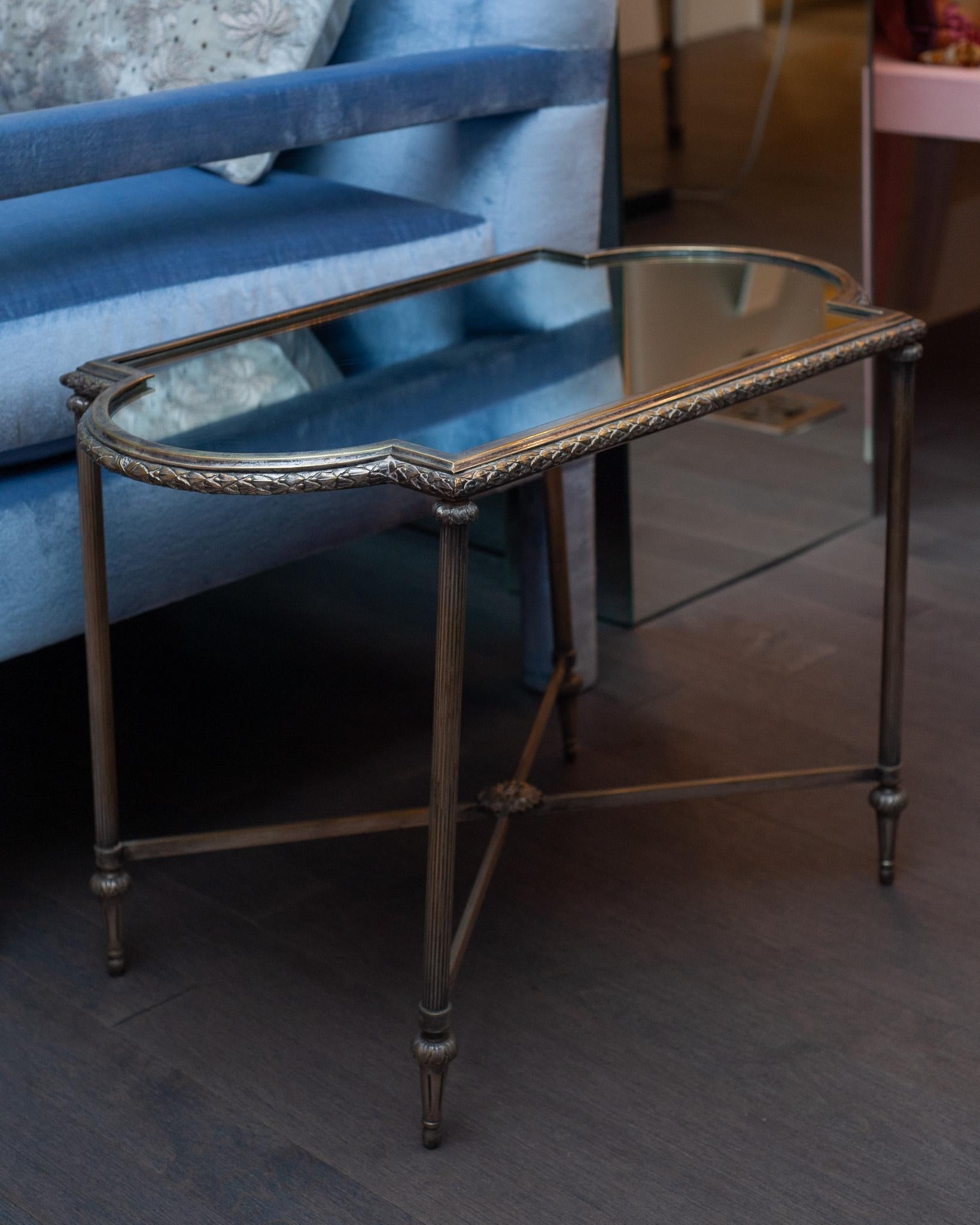 An exquisite French antique Christofle coffee table in silver metal with mirrored top. This beautiful table will add character and luxury to any neutral interior.