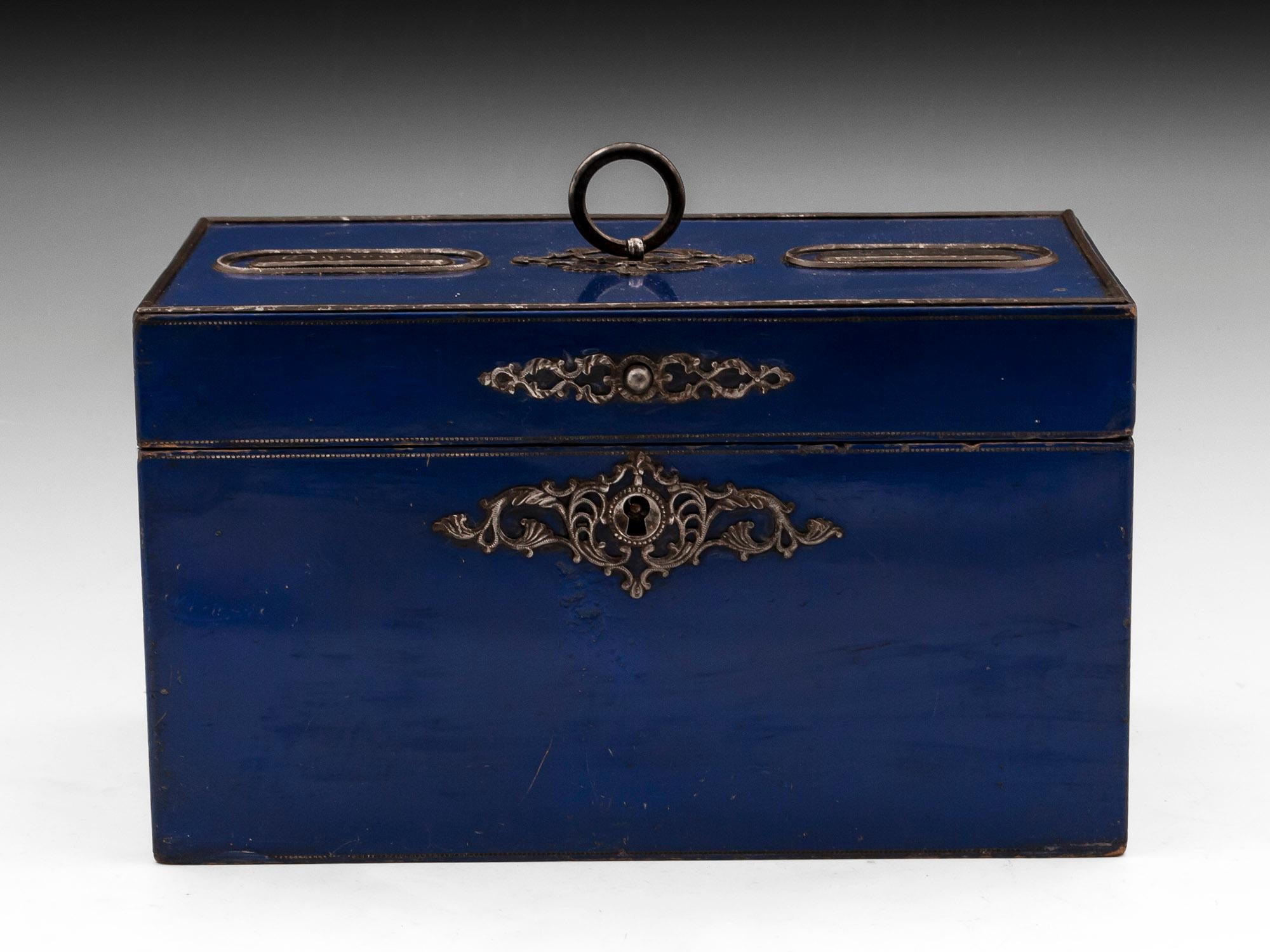 Vibrant blue Smokers Cigar & Tobacco box adorned with ornate cut steel escutcheon and a handles. The top has two steel plaques which read: 