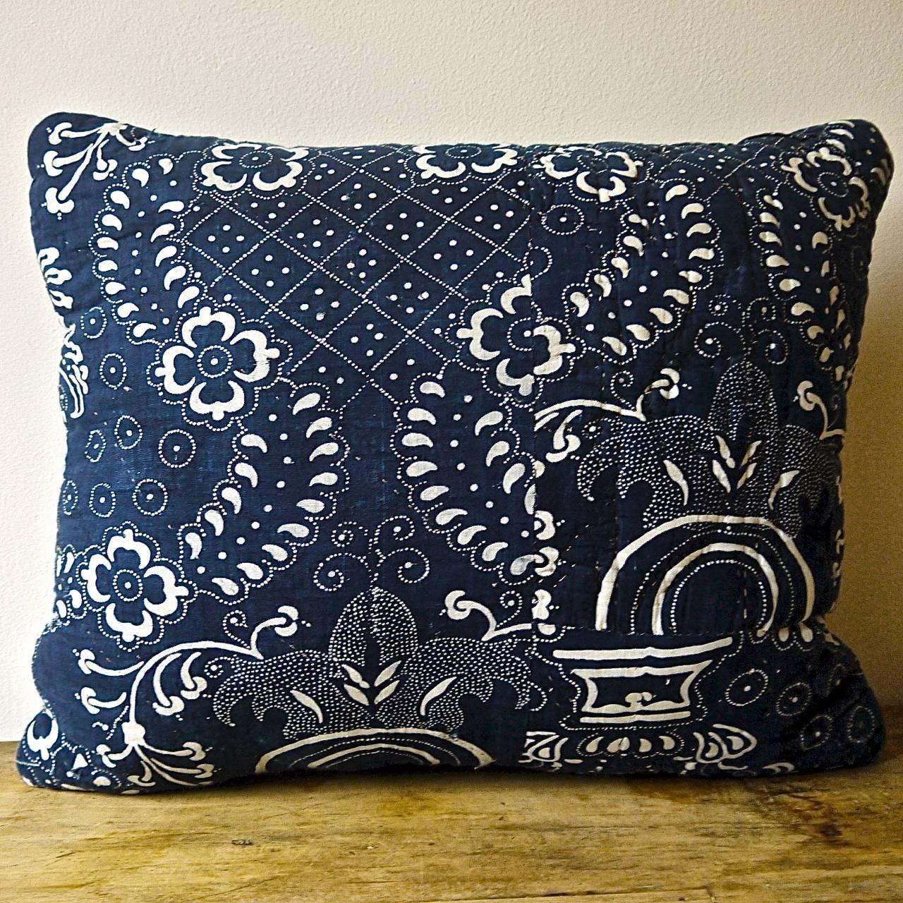 French Toile de Nimes indigo resist block printed cotton cushion. A striking design of stylized pomegranite and floral motifs. Simply quilted and printed on a soft cotton and backed in a dyed 19th century French linen. Slipstitched closed with a