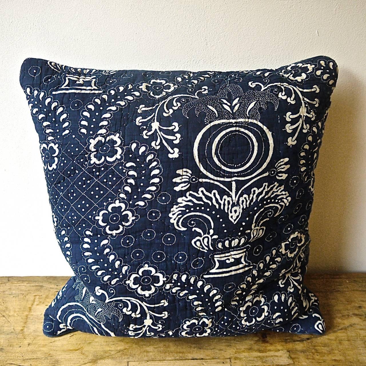 French Toile de Nimes indigo resist block printed cotton cushion. A striking design of stylized pomegranite and floral motifs. Simply quilted and printed on a soft cotton and backed in a dyed 19th century French linen that has a small stitched