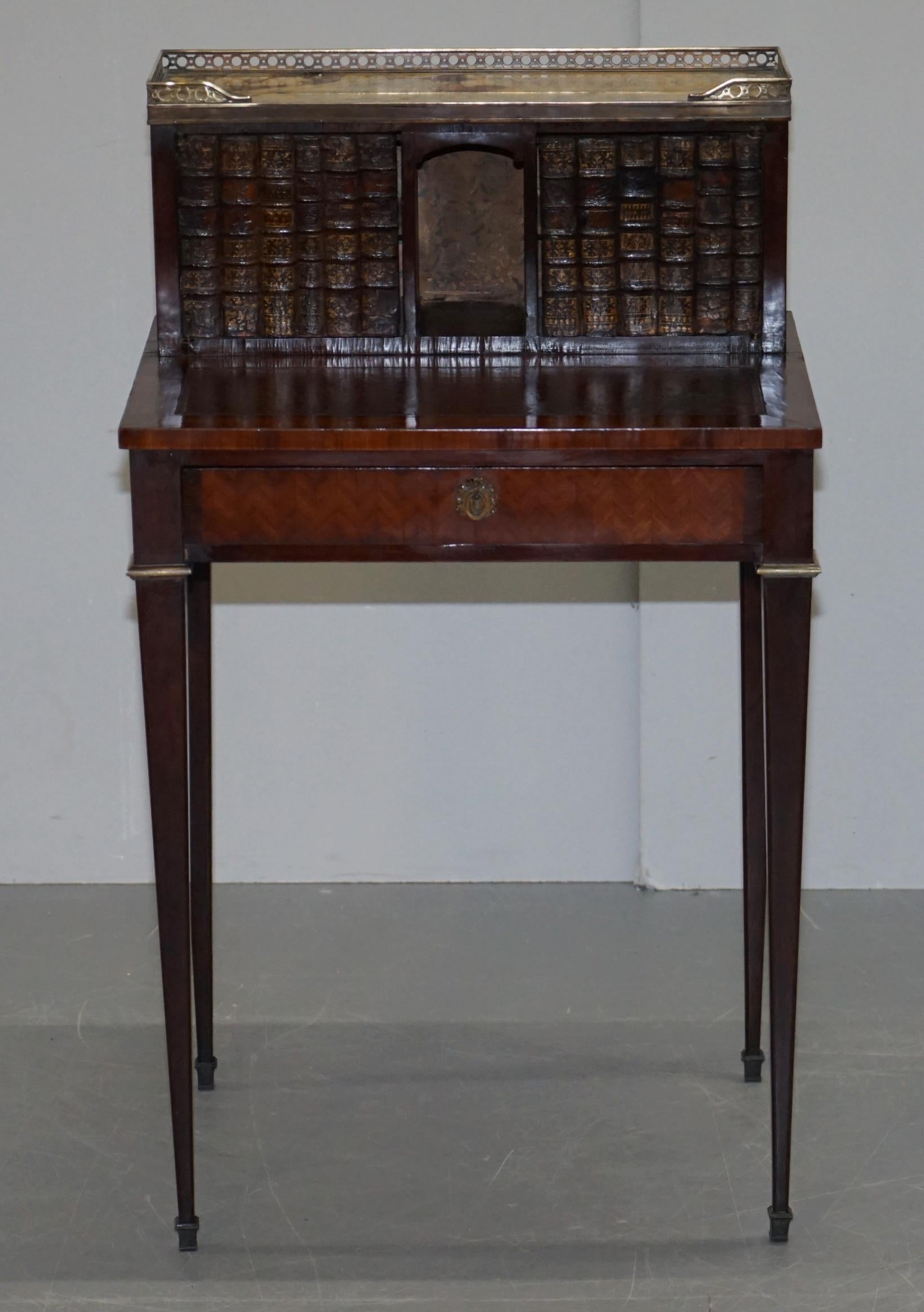 We are delighted to offer for sale this very rare fully restored circa 1870 hardwood and Parquetry Bonheur Du Jour with marble top surmounted by brass gallery rail, leather top and faux books

This is an exceptionally fine piece of antique