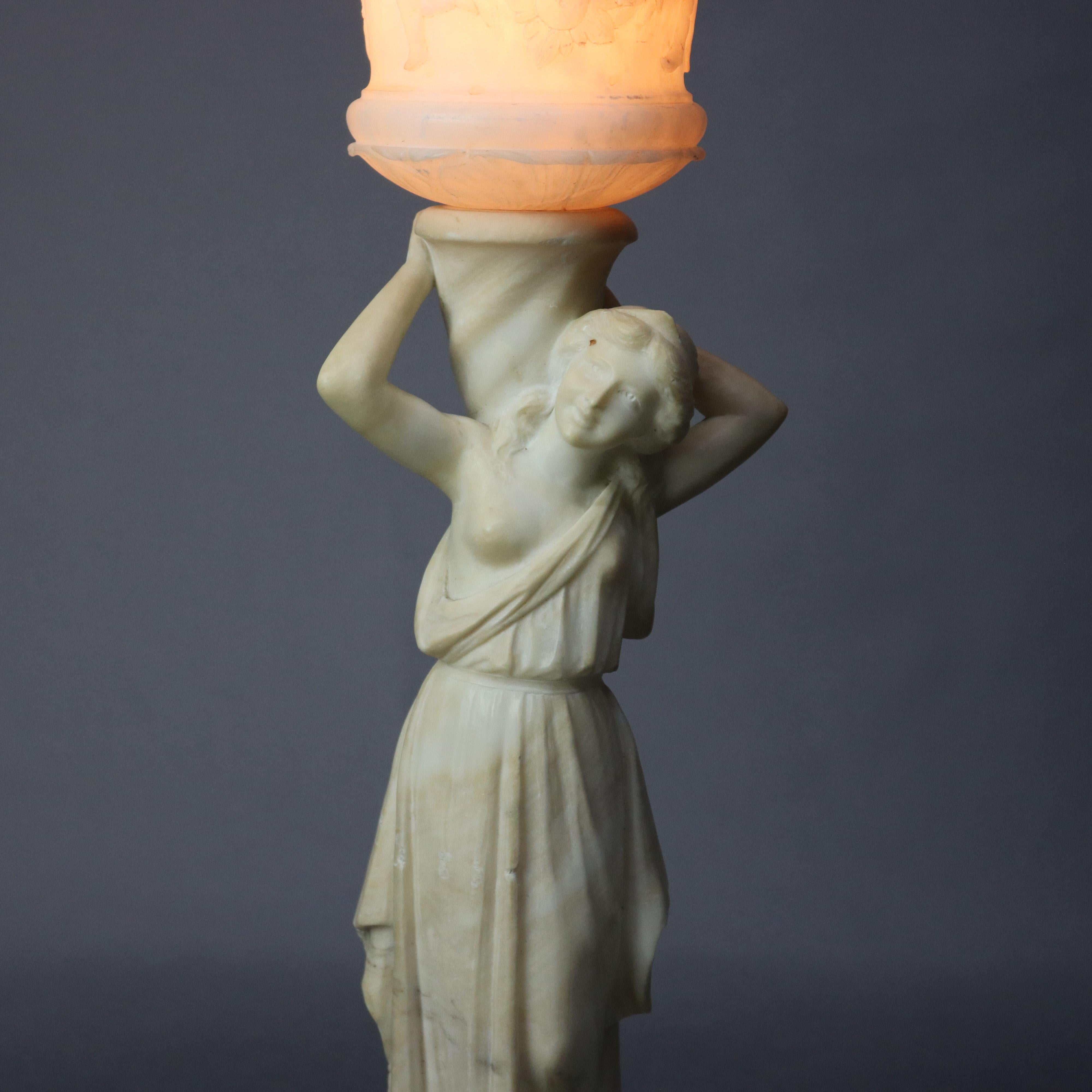 An antique French classical table lamp offers carved alabaster figural sculpture of your woman with urn having relief cherub scenes, circa 1920

Measures: 27.25