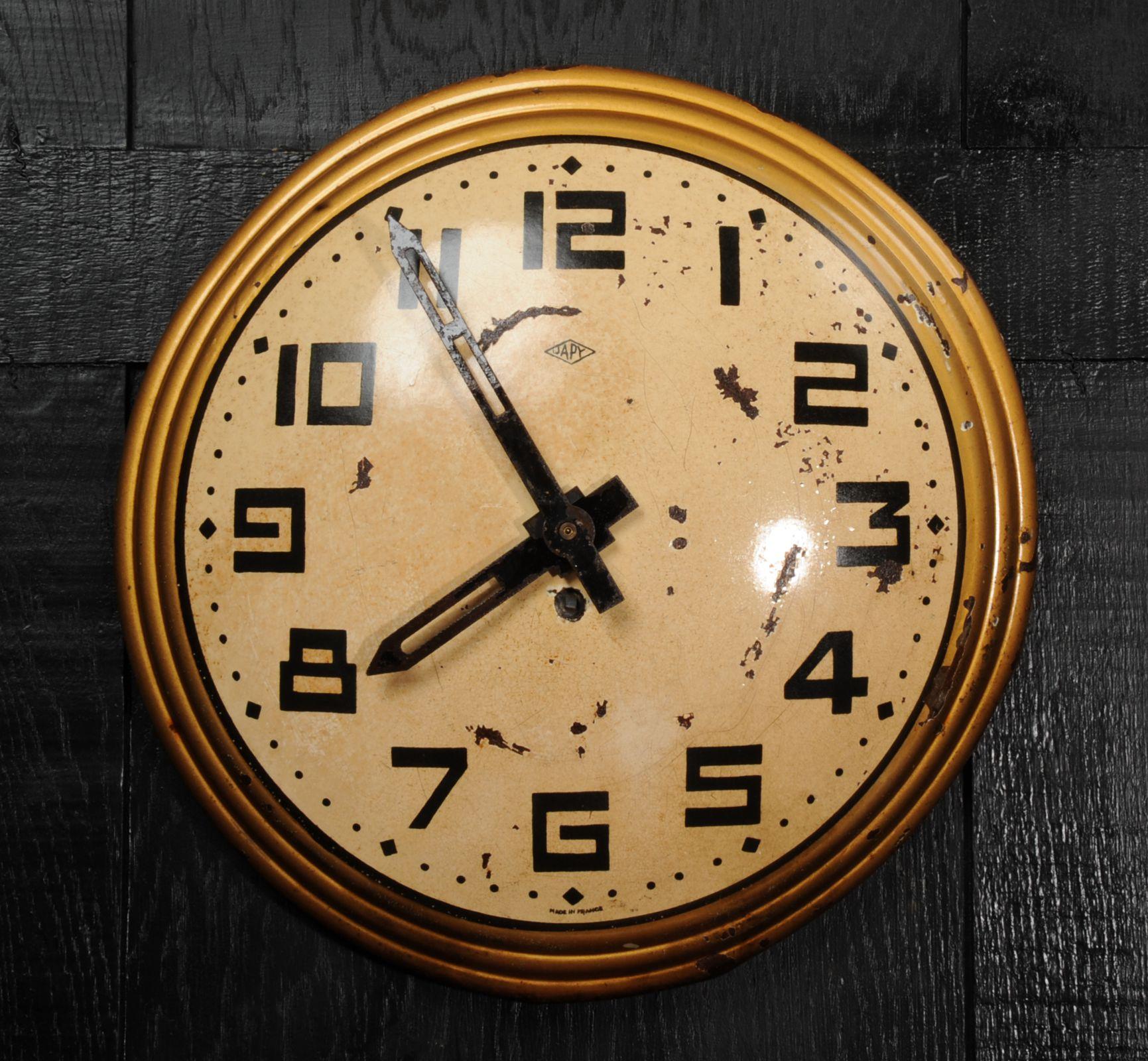 A wonderful early 20th century gold tole wall clock with a beautiful patination after years of neglect. The dark and light gold original finish is speckled with rust. Originally a mechanical movement by the famous maker Japy Freres, this was mostly