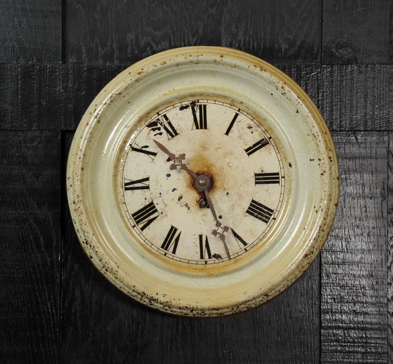 A lovely painted metal clock dial with original hands by Japy Frères. Recovered by our buyer from a crumbling and forgotten French industrial building, it bares the scars of a hard life. Painted tole wear with flaking paint and rust. The hands are