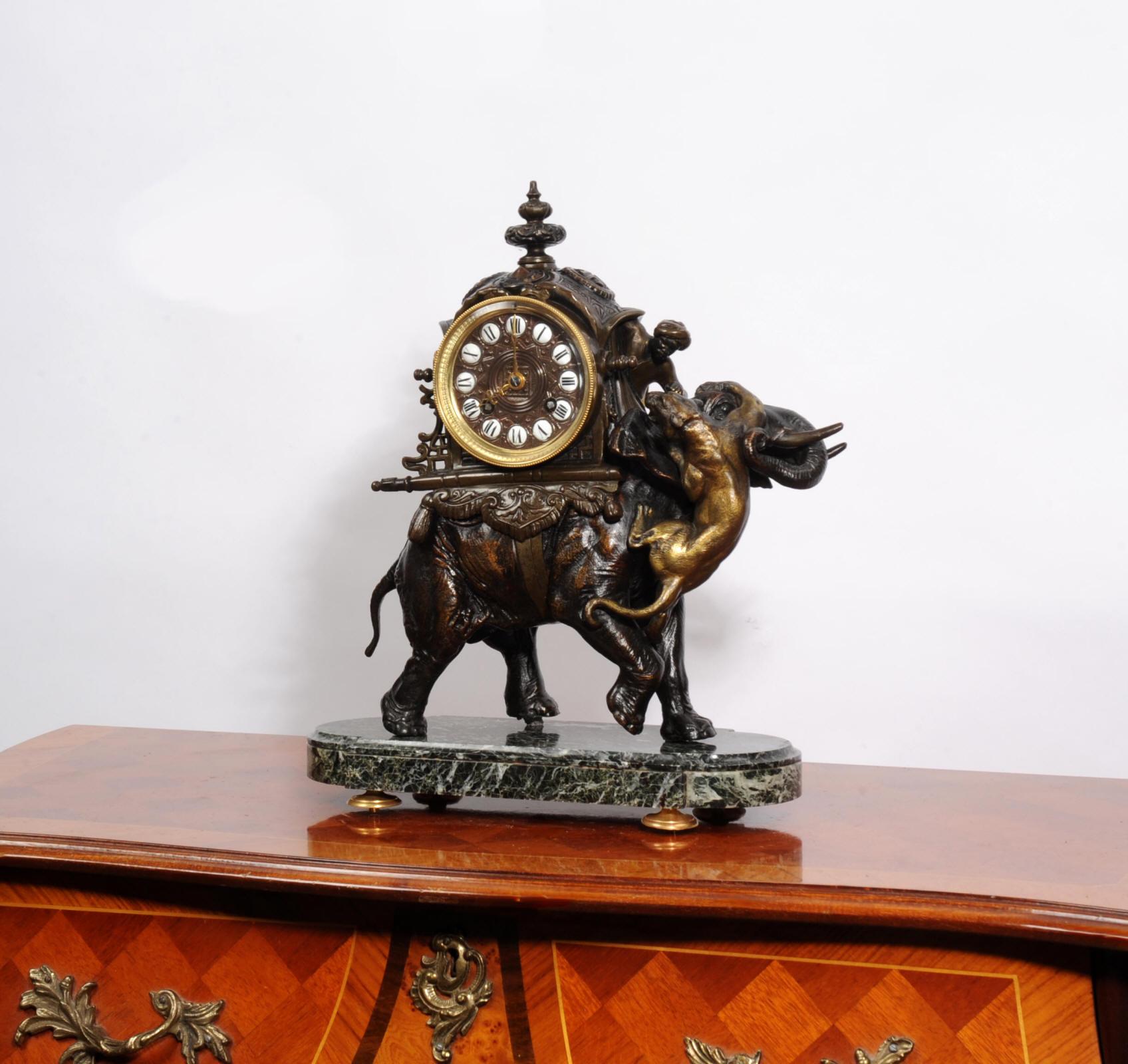 A rare and impressive antique French clock, modelled as an elephant carrying a howdah with a tiger being fought of by the mahout. Beautifully modelled in bronze patinated metal with highlights in gilt. The elephant is mounted on a green marble base