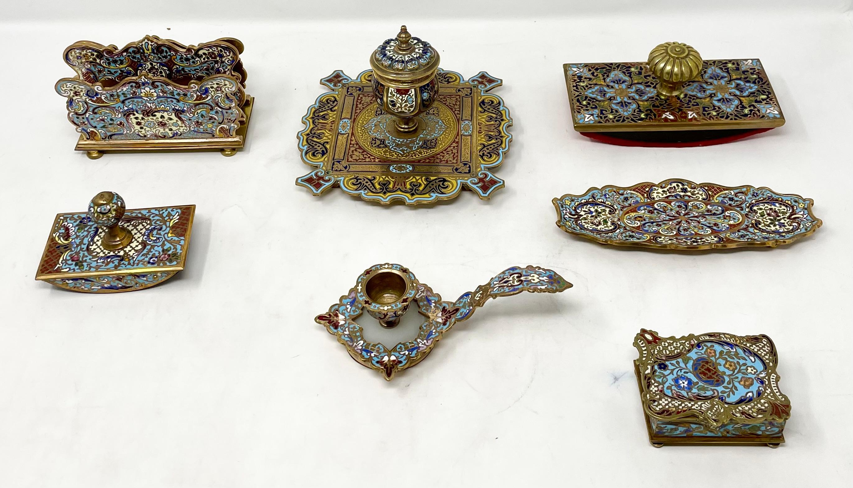 Antique French Cloisonné Enamel & Gold Bronze 7 Piece Inkwell Desk Set, Circa 1890.
Includes: Inkwell, Pen Holder, Drip Box (with pencil sharpener and shavings compartment), Letter Holder, Candle Holder, and 2 Rolling Stamps.