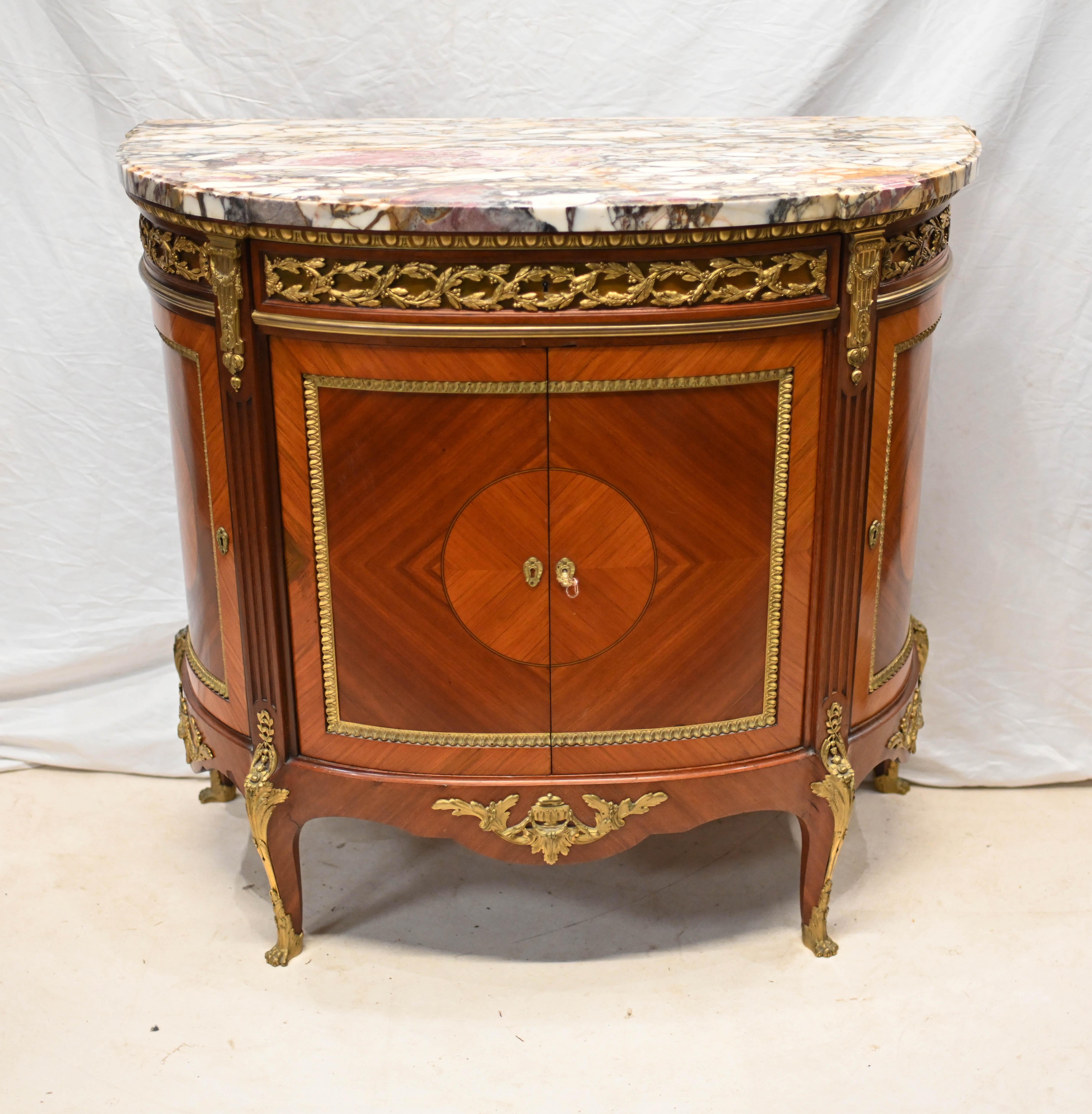 You are viewing a gorgeous French antique commode of demi lune form
Top quality demi lune side cabinet with king wood inlays and crossbanded rose wood
The fine quality ormolu mounts are tastefully gilded and original
Marble top is smooth and chip