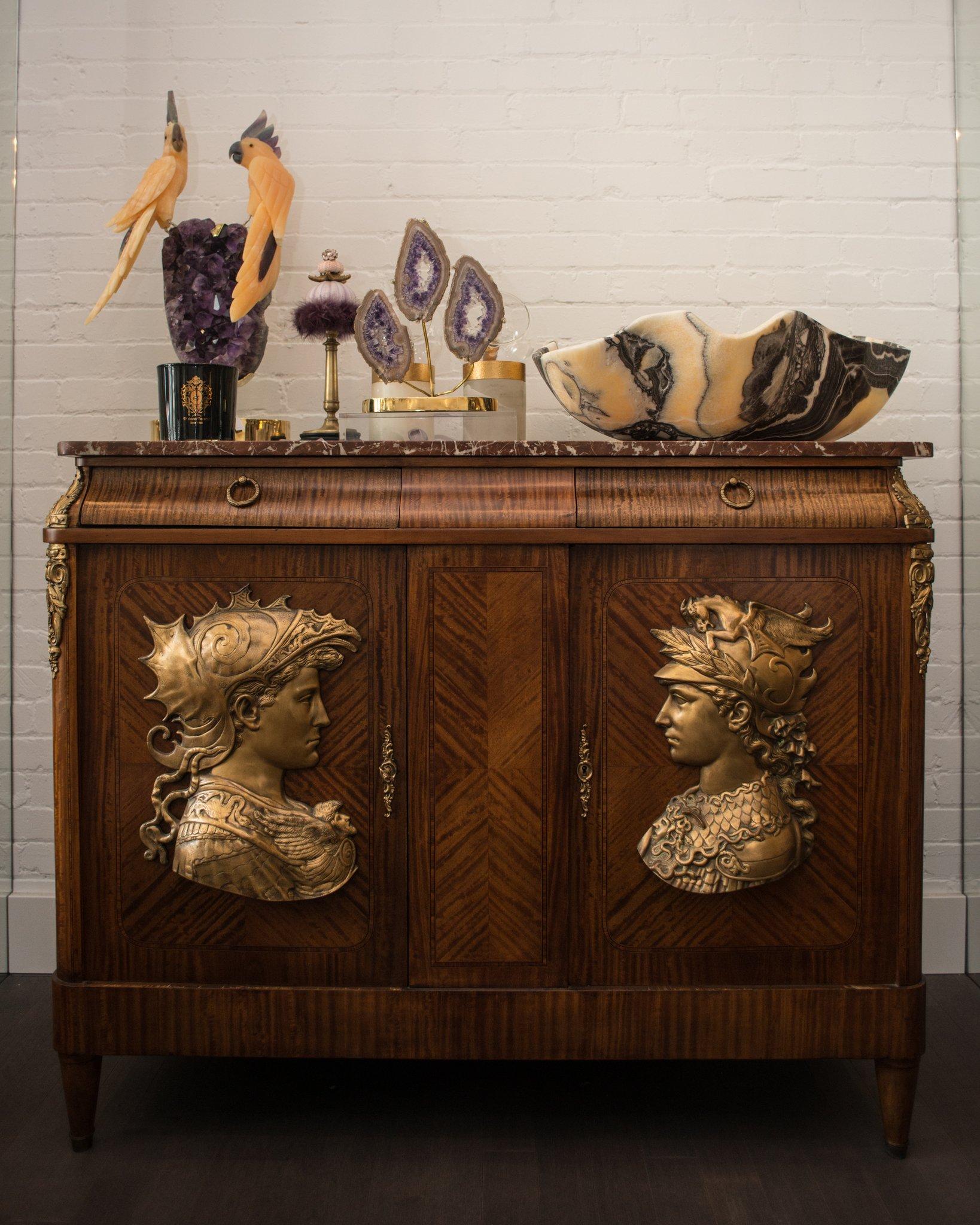 Our most coveted antiques are from the Napoleon III era. This spectacular French antique commode is the statement piece you’ve been looking for. What makes this commode so unique are the large Bronze reliefs on each door and the original Breccia