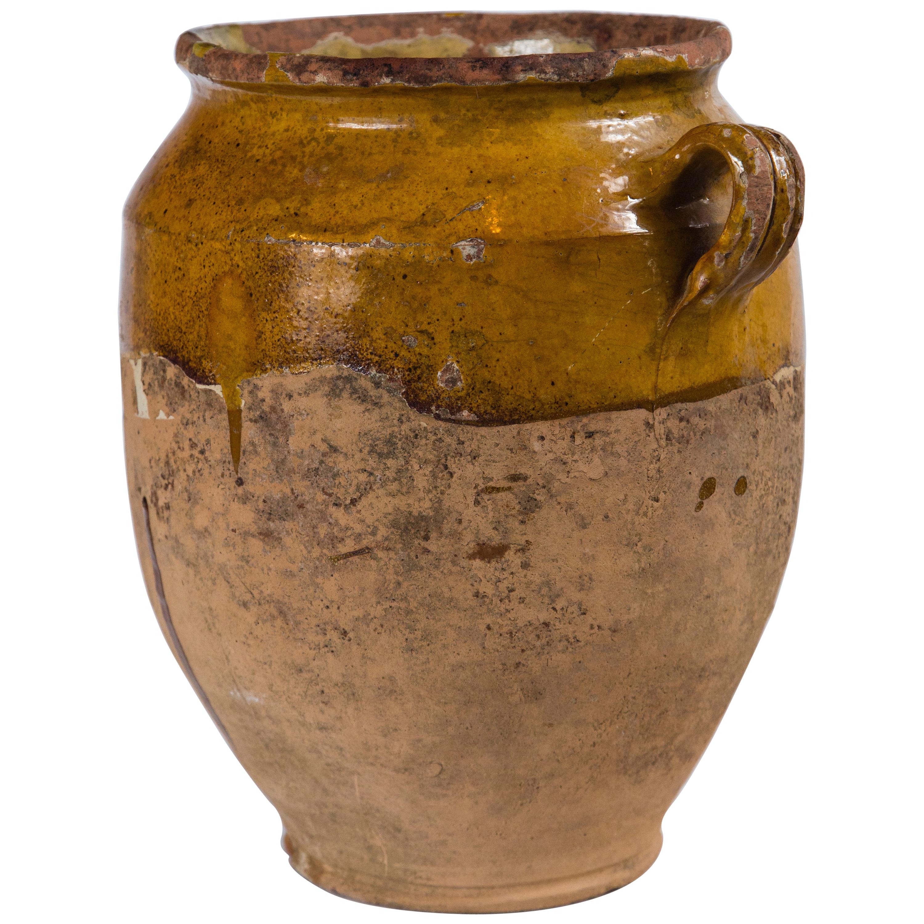 Antique French confit pot, late 19th century. Aged terracotta with yellow glaze. Confit pots were used for food preservation. The bottom half was left unglazed to allow the pot to keep cool while half buried in the ground.