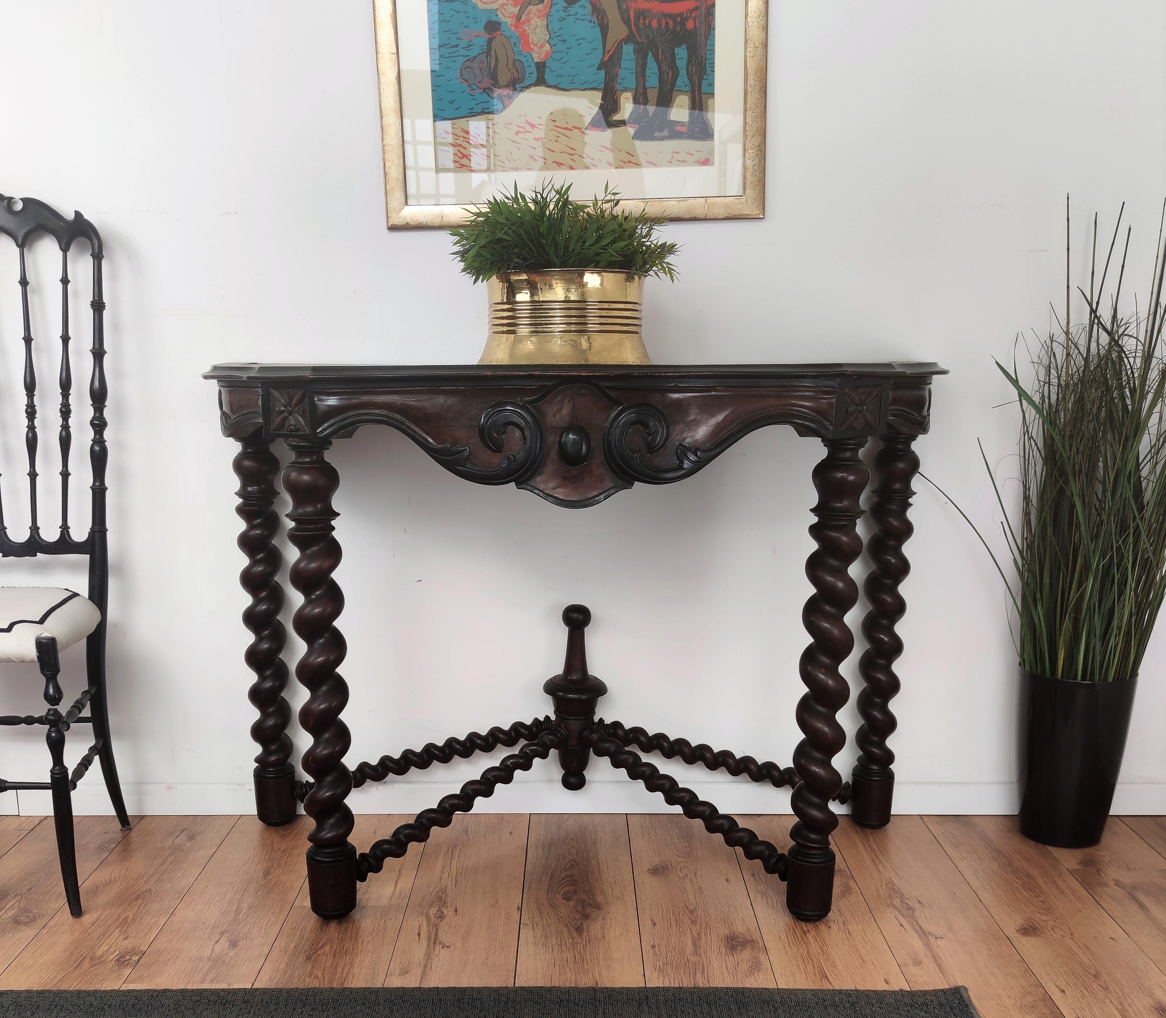 Beautiful and huge antique french console table or side end table, characterized by the handcrafted carved beveled edge table-top and hand carved decorated front apron, all with scalloped lower edges, raised on four stunning Barley twist turned legs