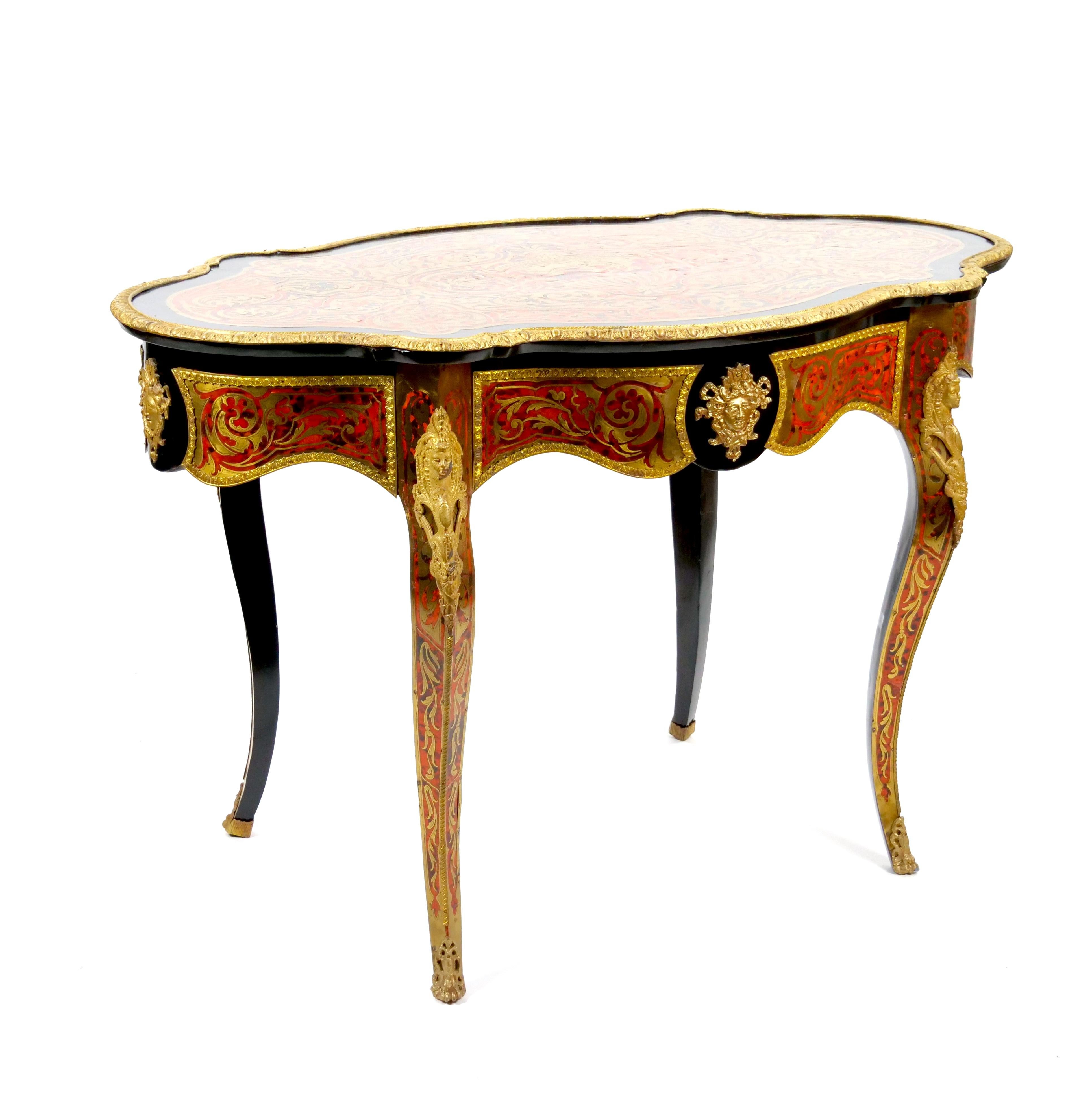 This magnificent 19th-century French Continental Boulle Desk / Center Table is a masterpiece of luxurious craftsmanship and timeless European elegance. Featuring an ebonized wood finish adorned with intricate gilt gold inlay details, this piece