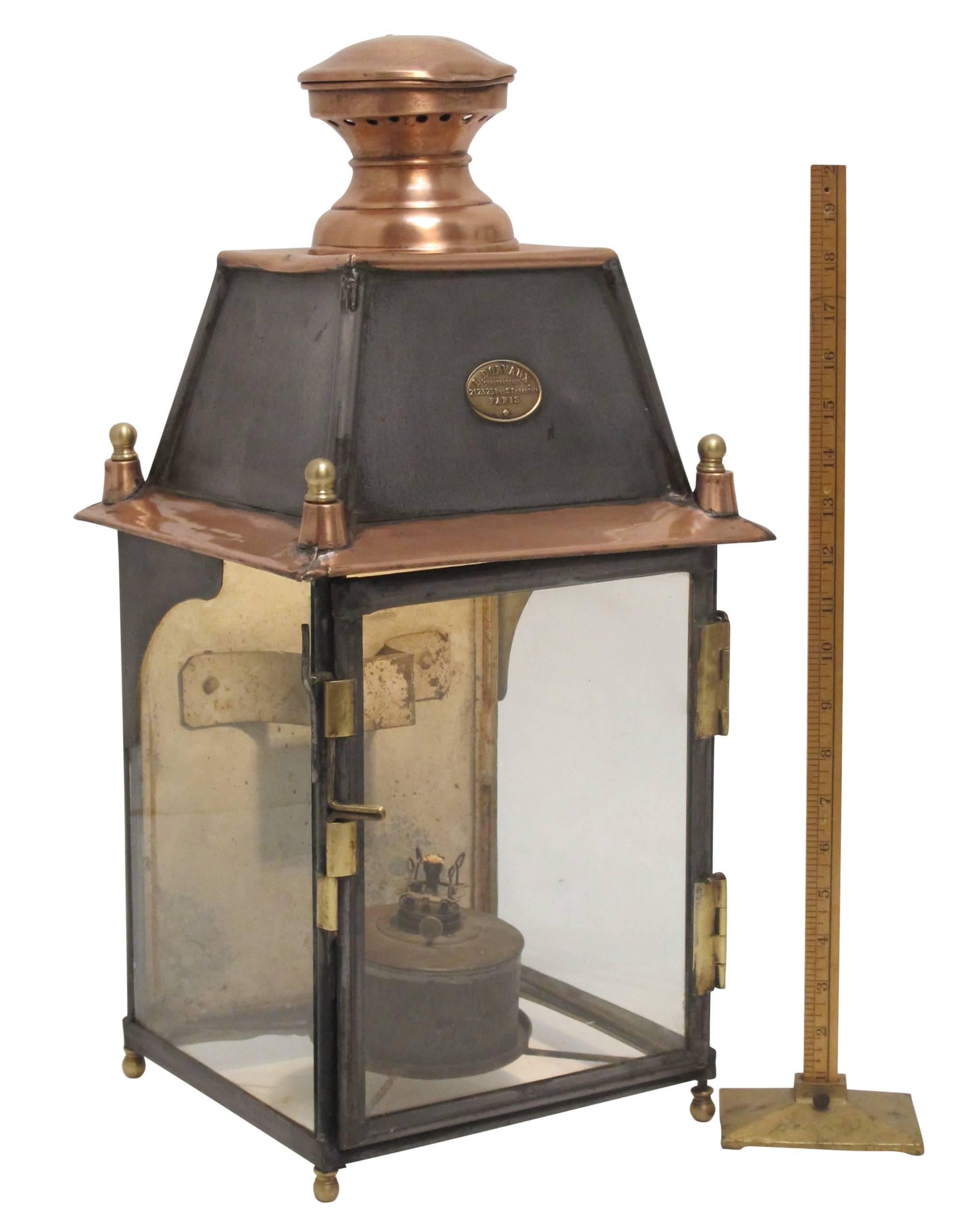 Large tin kerosene lantern, with copper chimney and brass detail, bearing the original oval label for L. Dorvaux Paris. Recently wired and used as a table lamp, but we will wire for exterior use if desired. France, late 19th century.
