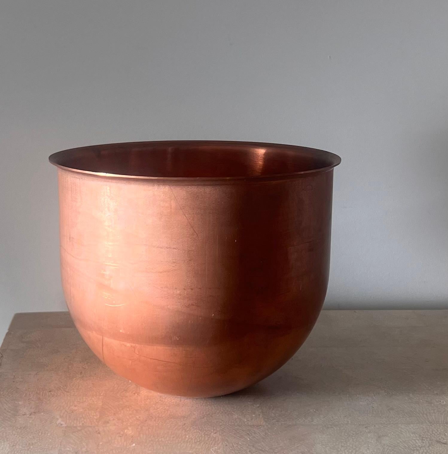 An antique copper bowl, made in France 19th century. Slight lip at the top and curved streamline base. 