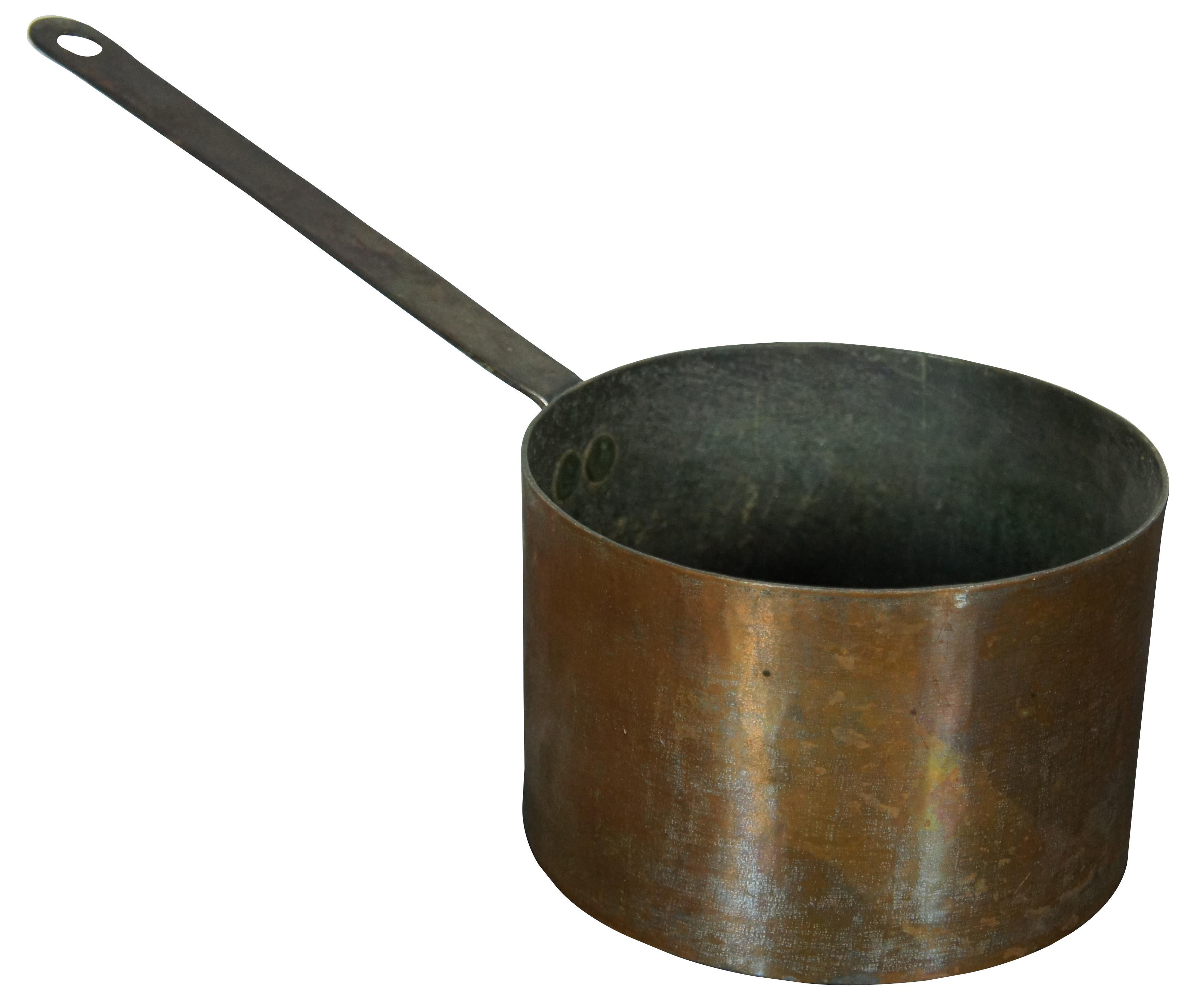 Antique copper sauce pan with iron handle; possibly marked with an M at the base of the handle.

Measures: 15.5” x 7.25” x 4.75” / Height of Handle – 8” (Width x Depth x Height).