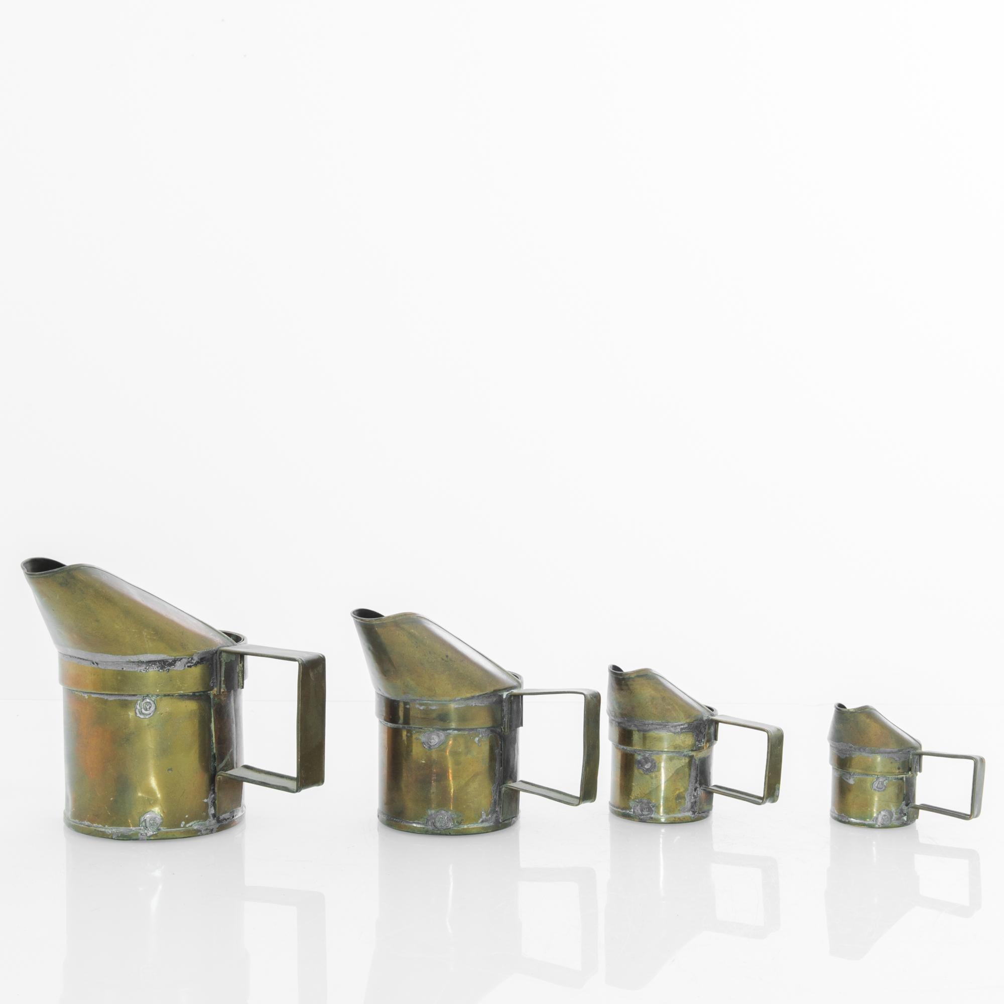 A set of four dry measures from Belgium, circa 1900. Early on in its life, these grain scoops lived as critical tools in commercial transactions—counting off consistent measures, keeping accounts square. Now retired, it’s the perfect accent piece