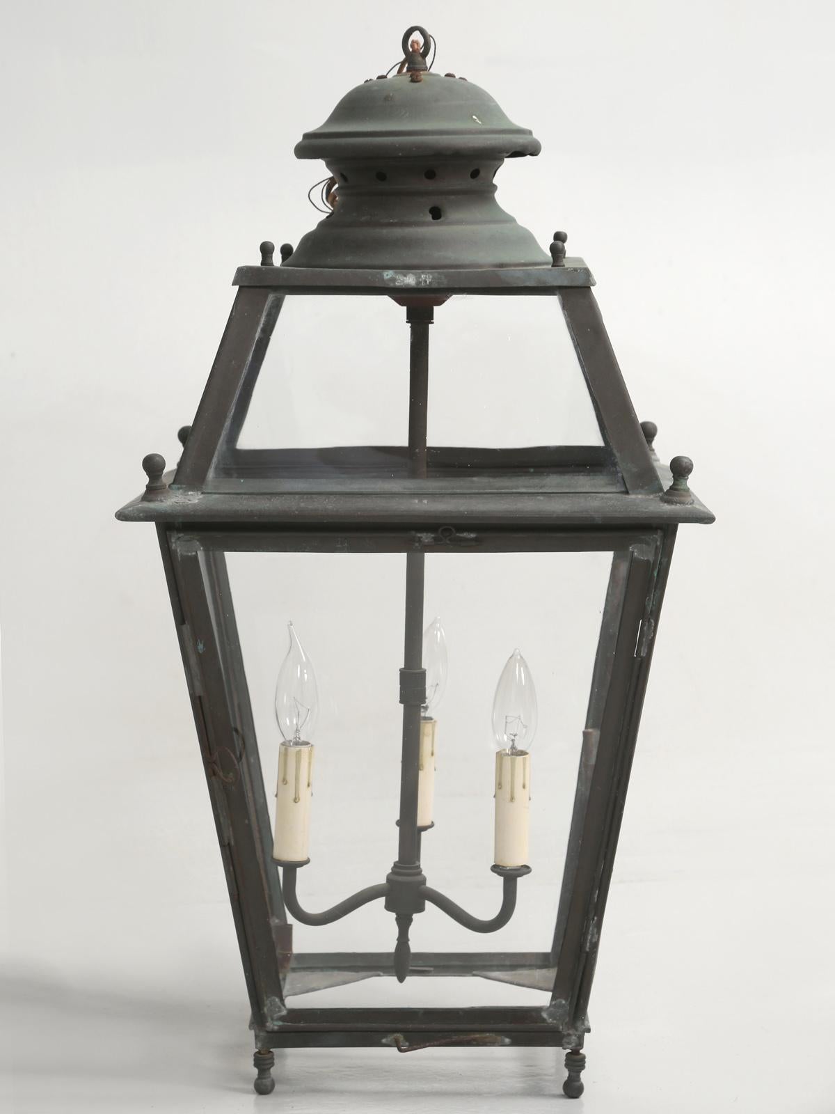Antique French copper lantern, that we imported and restored correctly; even fitting it with handmade French wavy glass. Rewired for the states and with a beautiful natural patina.