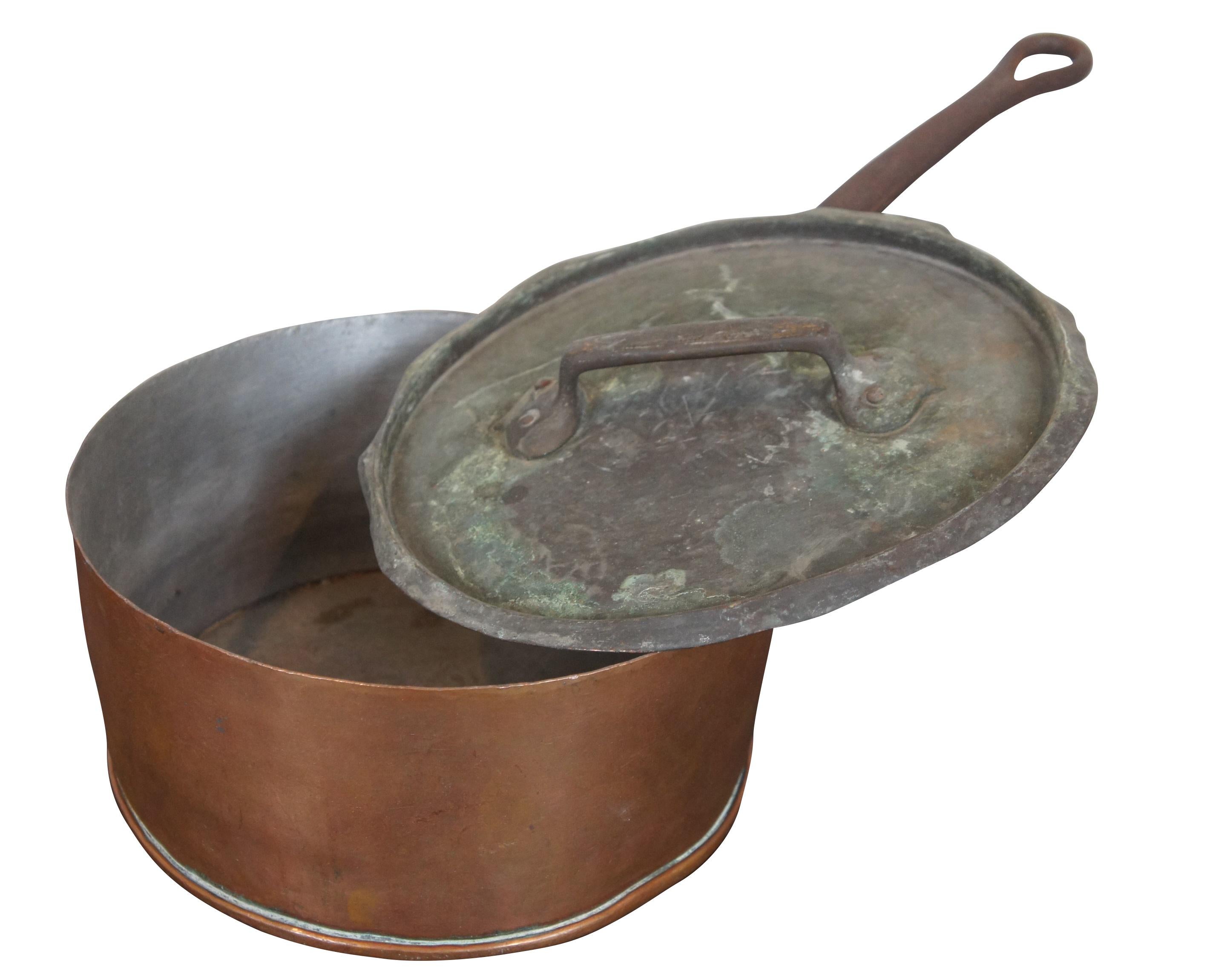 Antique French copper cook pot or saute pan featuring cast iron handle and lid. Measure: 21
