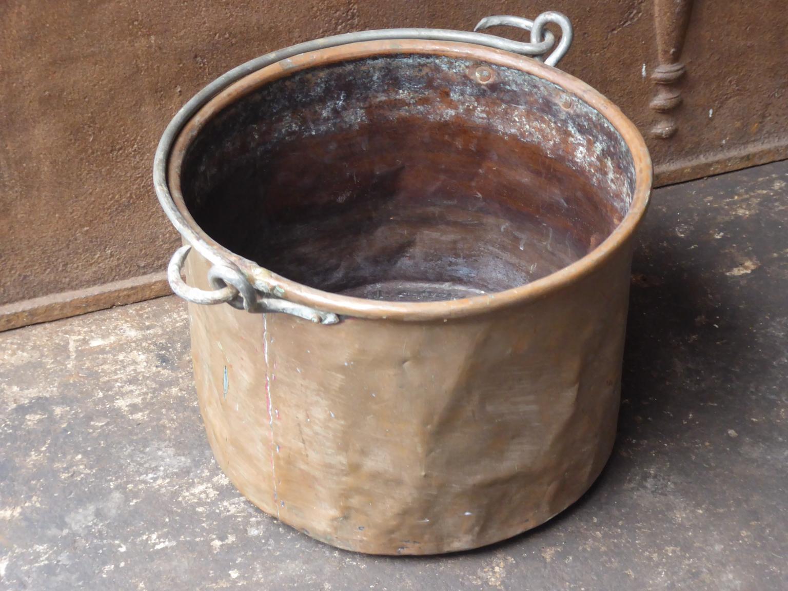 Panier à bûches hollandais du 18e siècle. Le panier à bois de chauffage est fabriqué en cuivre et possède une poignée en fer forgé. Le porte-bûches est en bon état et fonctionne parfaitement. La largeur totale du panier, poignées comprises, est de