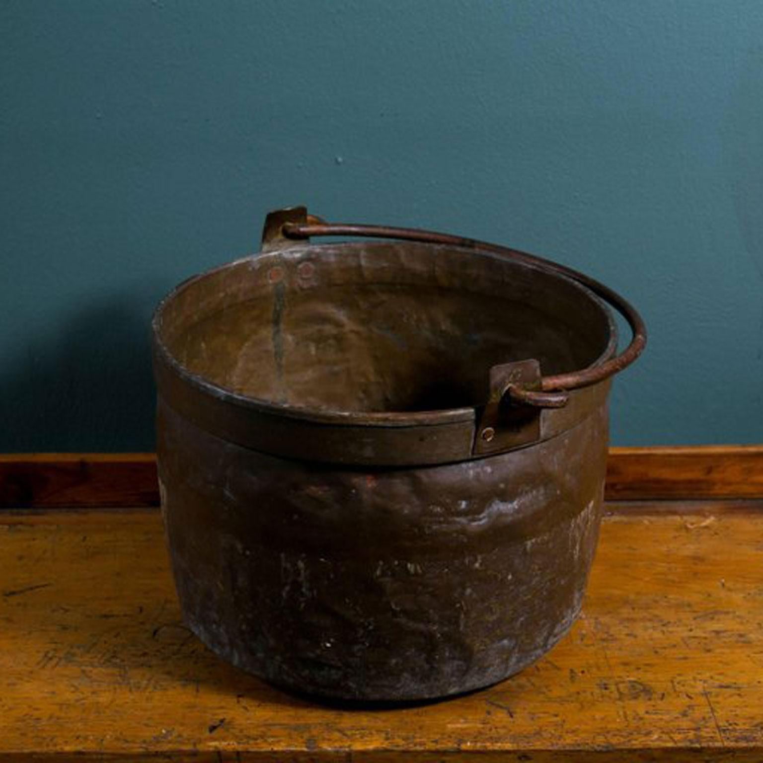 Antique French copper pot or bucket with iron handle, circa 1890. All hand forged with beautiful patina. Multiple pots available - all similar in size but each one-of-a-kind. Makes an attractive decorative accessory or container for firewood,