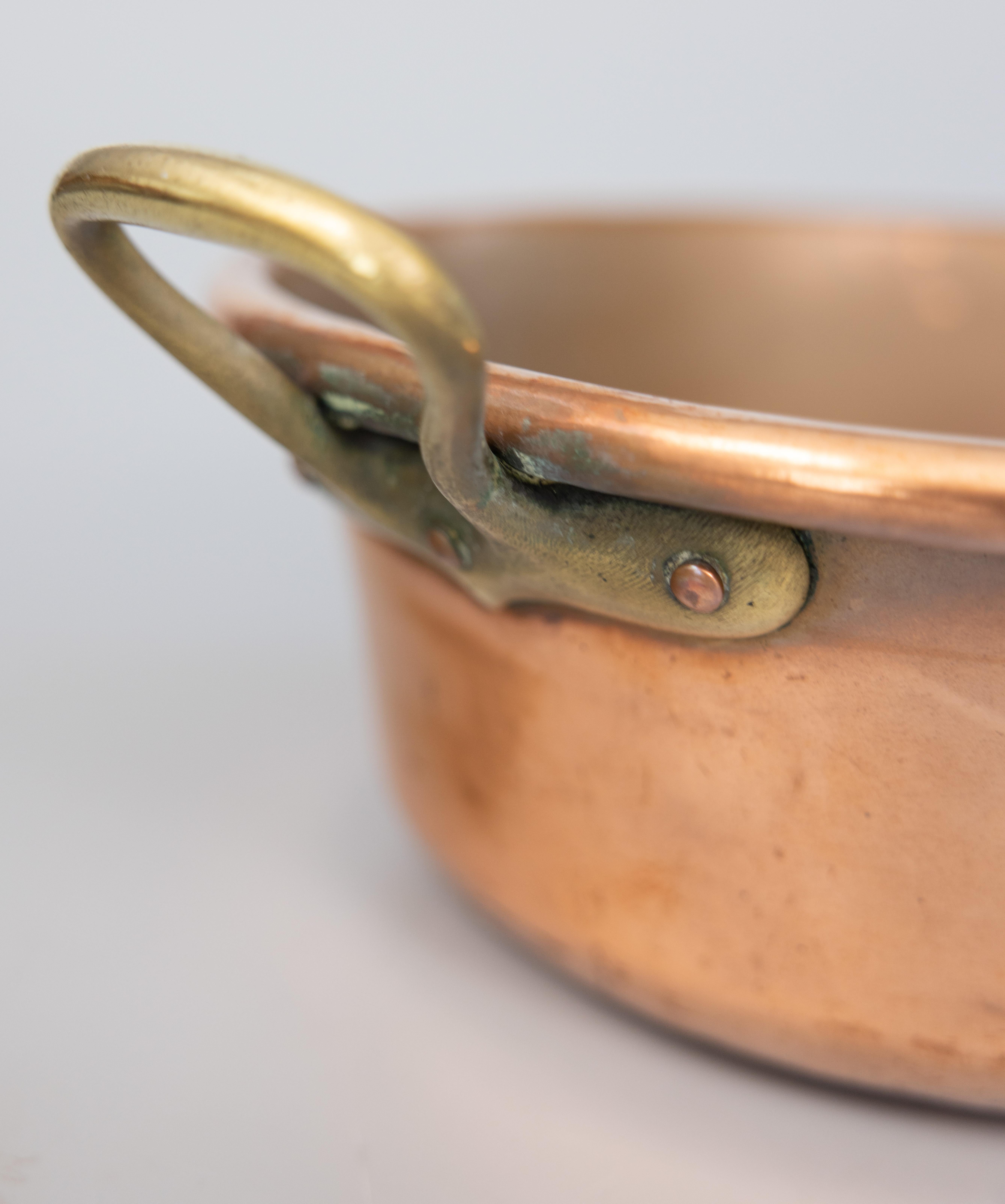 vintage copper pot with brass handles