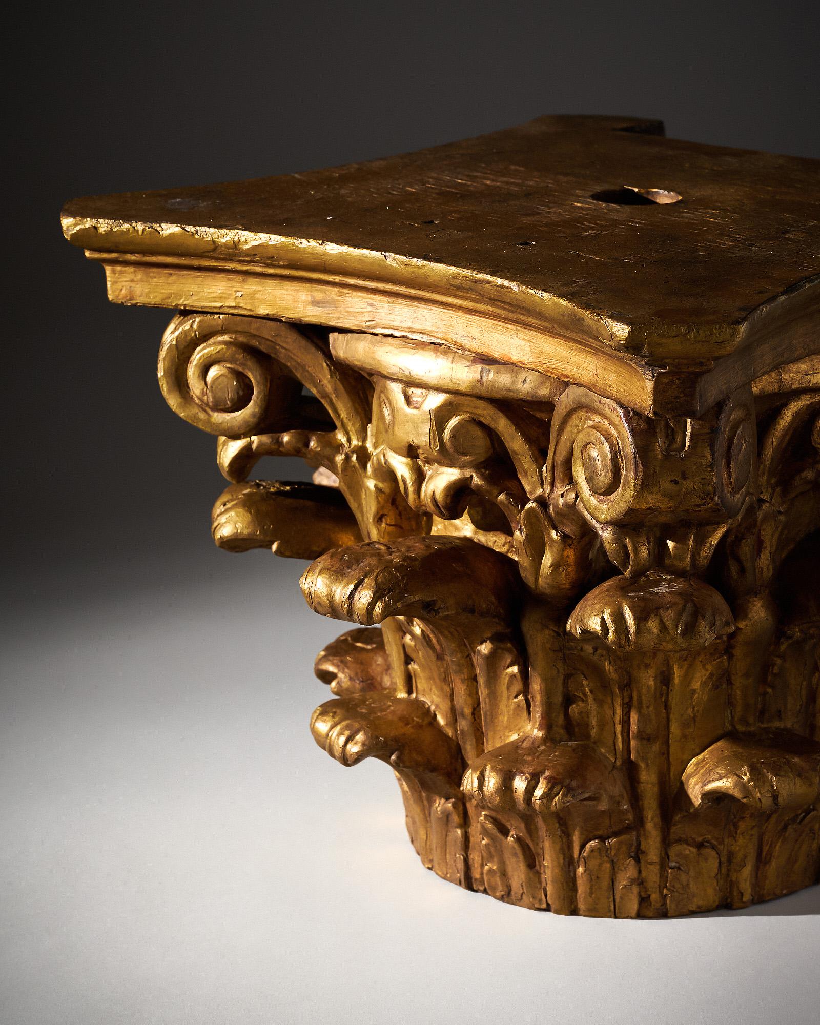 Corinthian Capital, French, of finely hand carved wood finished with 24 carats gold leafing. The architectural element which can serve as  a side table features a hand carved décor of Acanthus leaves and scrolls. This piece is in very nice antique
