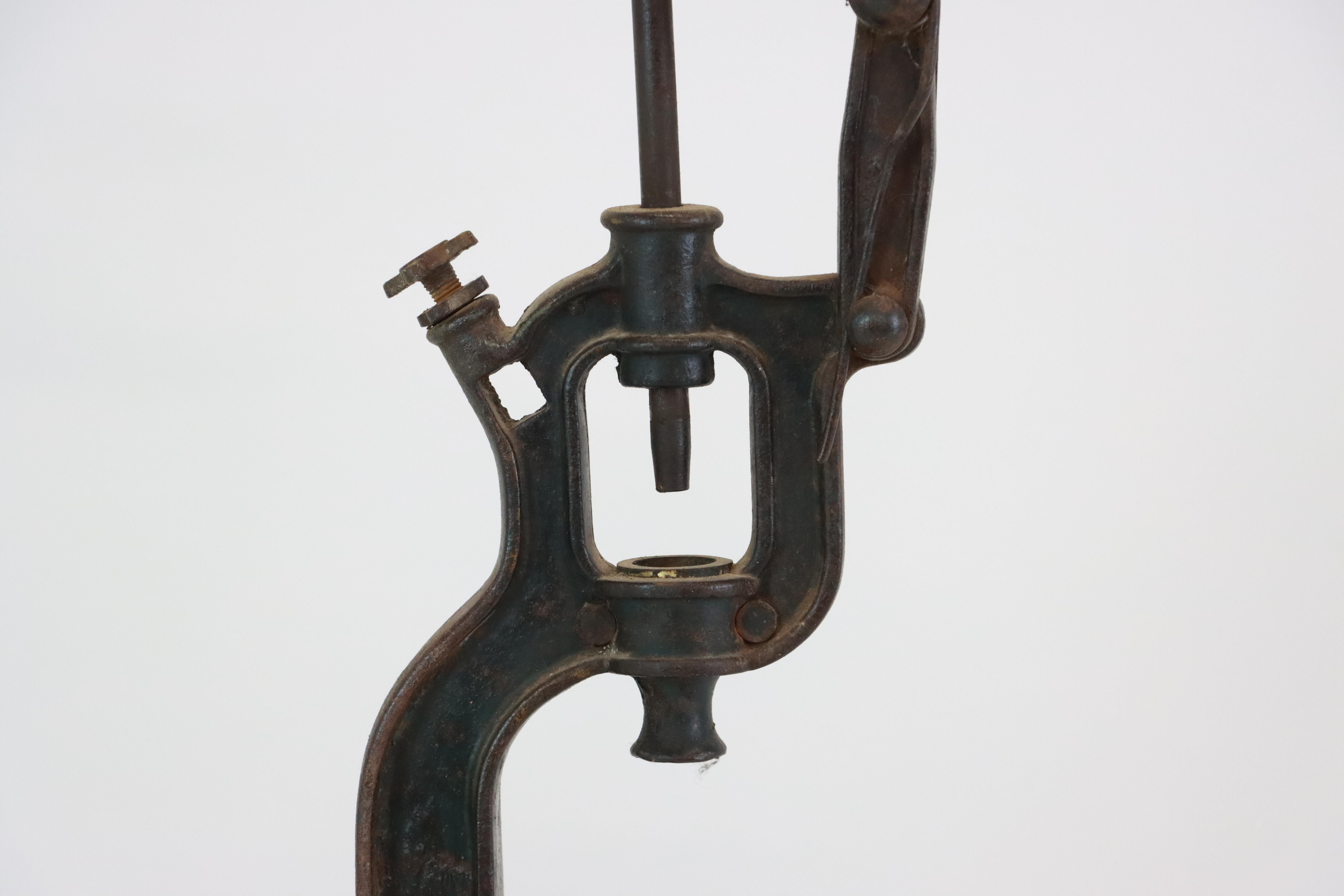 A beautifully crafted antique French hand-operated corking machine, once used in wineries for sealing bottles with corks.

The corker has an arched lever, adjustable bottle-height screw, and twin round platforms to securely cradle the bottle during