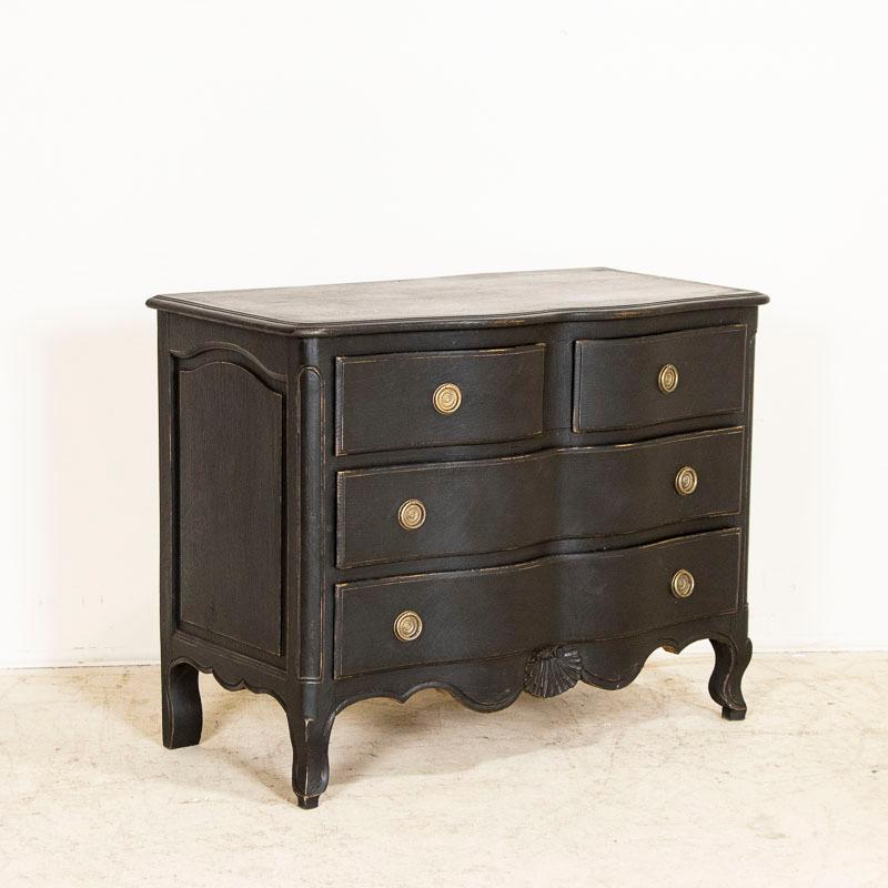 This delightful antique chest of drawers has been given new life with a recent black painted finish. Note in the photos the slight distressing which compliments its age and brings out touches of the natural oak wood beneath. The graceful cabriolet
