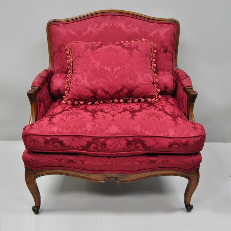 Antique French Country Louis XV style carved mahogany settee. Item features partial down filled cushion, bolster pillow, solid wood construction, and cabriole legs, circa 1950. Measurements: 34.5