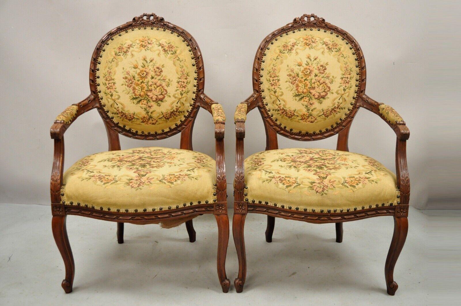 Antique French Country Louis XV Victorian Style Floral Tapestry arm chairs - a Pair. Item features a ribbon and rose carved crest, floral tapestry upholstery, solid wood frames, upholstered armrests, cabriole legs, very nice vintage pair. Circa
